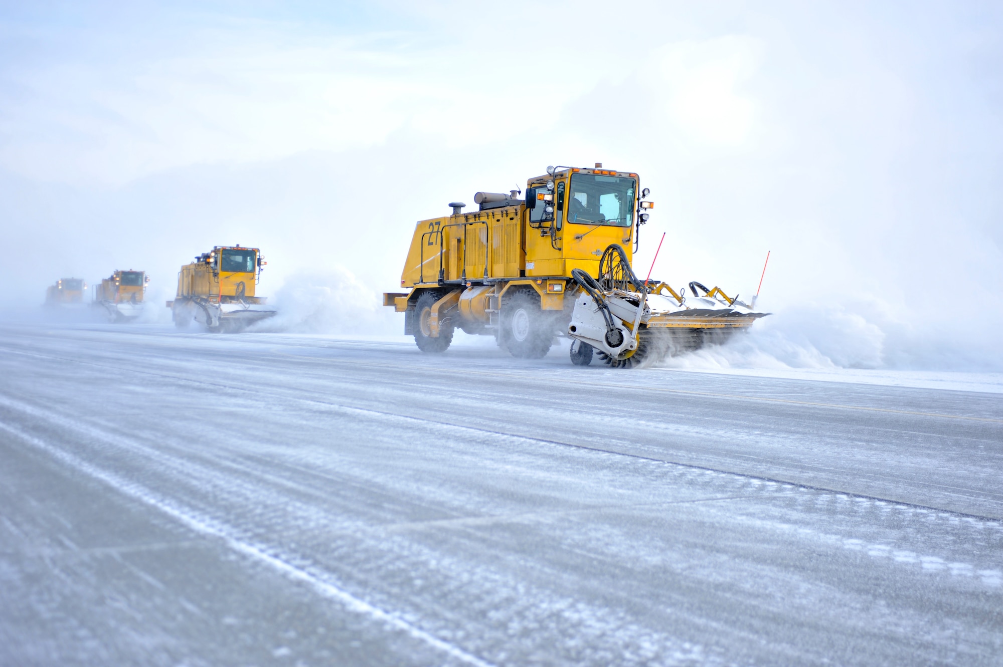 ELMENDROF AIR FORCE BASE, Alaska – Members of the 3rd Civil Engineer Squadron drive snow brooms down the flightline to clear it of snow March 10. (U.S. Air Force photo/ Airman 1st Class Jack Sanders)