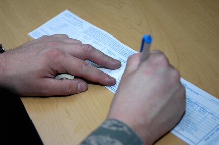 Airman 1st Class Derek Kasper signs a pledge for the Air Force Assistance Fund at Joint Base Charleston, S.C., March 19, 2010. The AFAF campaigns to provide benefits such as no-interest loans to Airmen in need during a time of hardship. Airman Kasper is the 22nd Airman from the 628th Logistics Readiness Squadron to donate to the AFAF this year. Airman Kasper is an individual protective equipment apprentice with the 628 LRS. (U.S. Air Force Photo/Airman 1st Class Lauren Main)