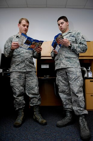 Second Lieutenant Charles Morton explains the Air Force Assistance Fund to Airman 1st Class Derek Kasper at Joint Base Charleston, S.C., March 19, 2010. Airmen from the 628th Logistics Readiness Squadron have contributed $2,337 since the campaign began March 8. The campaign is slated to end April 16. Lieutenant Morton is the 628th Logistics Readiness Squadron materiel management flight commander and unit AFAF representative. Airman Kasper is an individual protective equipment apprentice with the 628 LRS. (U.S. Air Force Photo/Airman 1st Class Lauren Main)