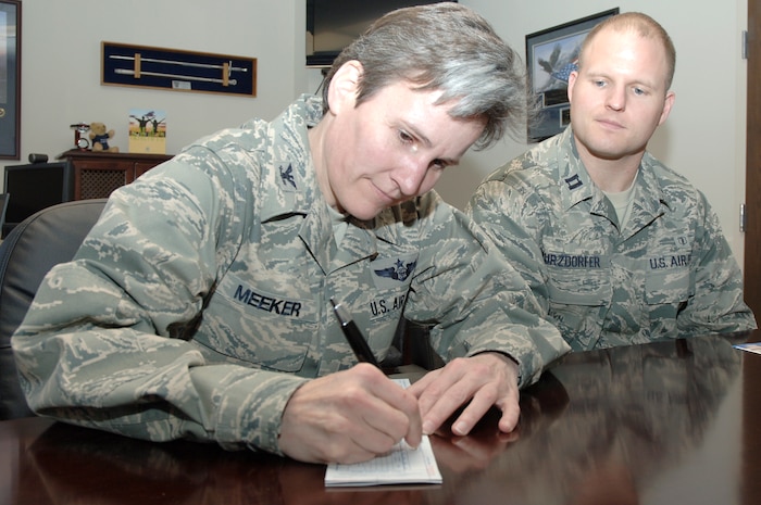U.S. Air Force Col. Martha Meeker fills out an Air Force Assistance Fund donation form as Capt. James Kurzdorfer guides her through the steps March 9, 2010, at Joint Base Charleston, S.C. The AFAF campaign at Charleston runs March 8 through April 16 and provides the opportunity to donate to four organizations which give back to Airmen. Colonel Meeker is the 628th Air Base Wing commander and Captain Kurzdorfer is the AFAF installation project officer. (U.S. Air Force photo/Staff Sgt. Marie Brown)