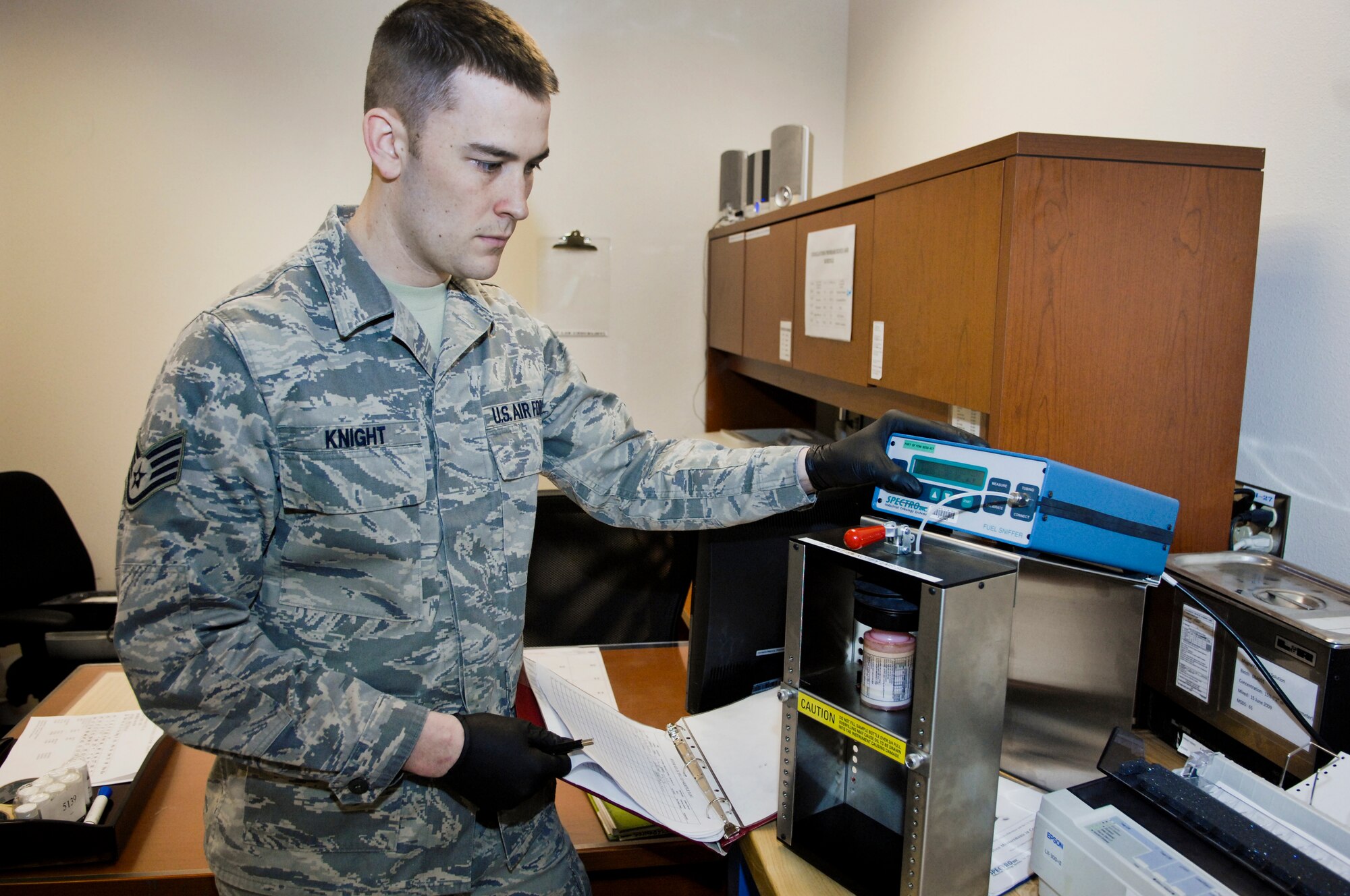 ELMENDORF AIR FORCE BASE, Alaska -- Staff Sgt. Aaron Knight, 3rd Equipment Maintenance Squadron NDI craftsman, tests F-22 hydraulic fluid for contamination March 18 with an F-22 Hydraulic Fluid Fuel Contamination Tester is often referred to as a "fuel sniffer". (U.S. Air Force photo/ Airman 1st Class Jack Sanders)