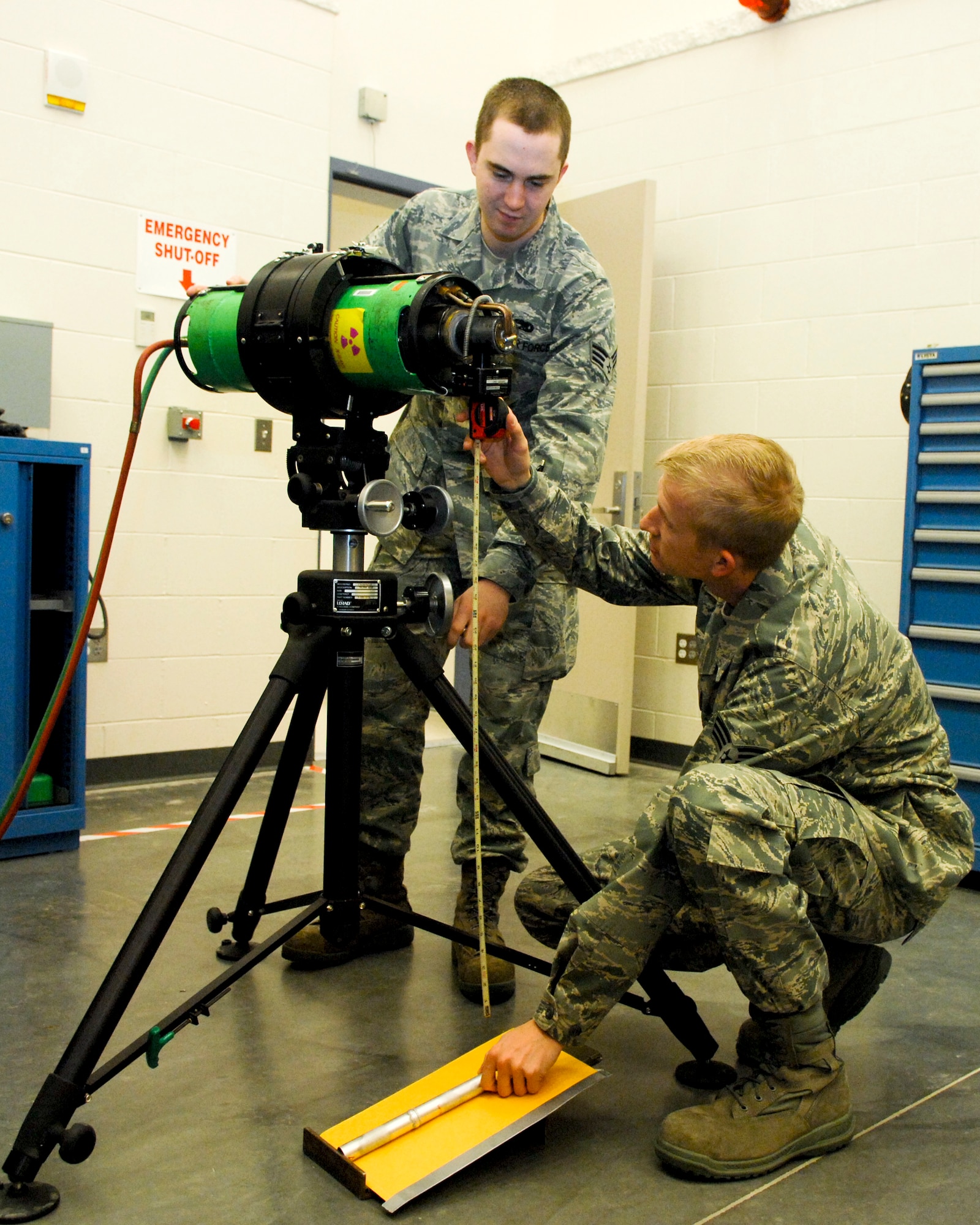 ELMENDORF AIR FORCE BASE, Alaska -- Senior Airman Logan Nutter (standing) and Senior Airman Tyson Heckert, 3rd Equipment Maintenance Squadron NDI journeymen, set up a pipe for a weld certification March 18. (U.S. Air Force photo/ Airman 1st Class Jack Sanders)