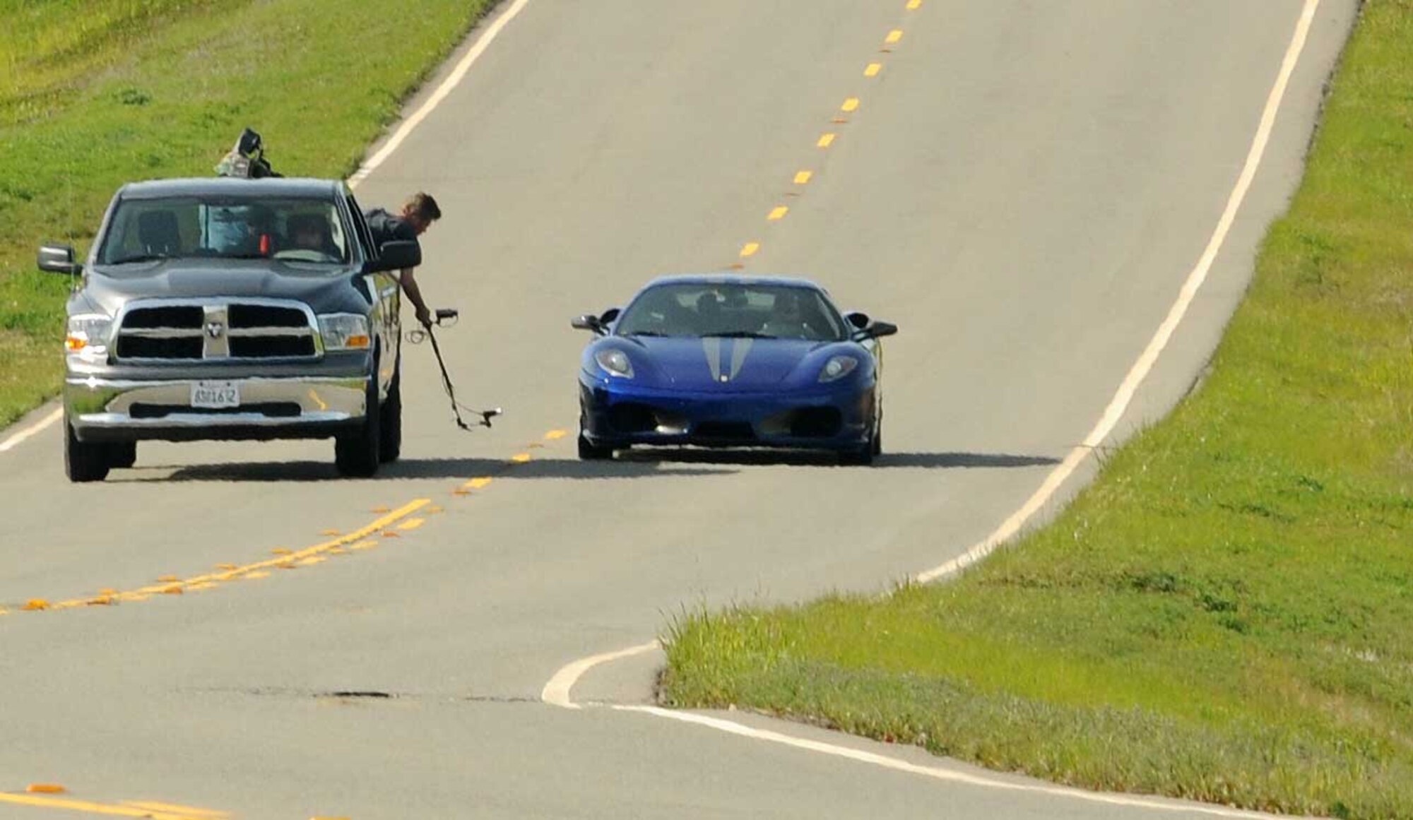 Camera crews take footage for the SPEED Channel Battle of the Supercars edpisode March 18 near the housing area. The Ferrari F430, driven by famed open-wheel racer Paul Tracy, matched up against a Porsche 997 GT3RS. (Air Force photo by Airman 1st Class David Tracy)