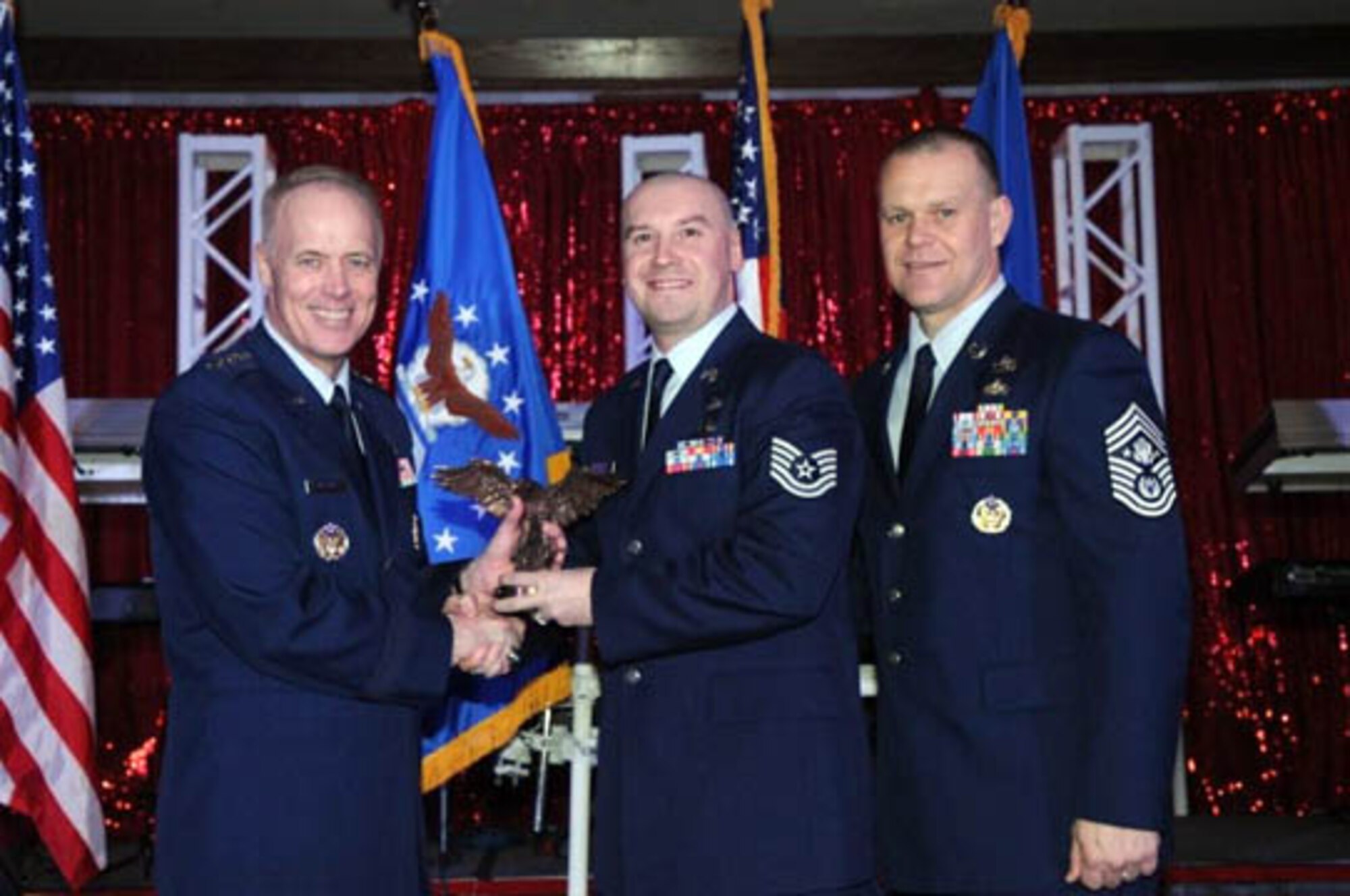 Tech. Sgt. McKinstry (center), 926th Mission Support Squadron, is presented with Air Force Reserve Command's Education and Training Non-commissioned Officer of the Year award by Lt. Gen. Richard Newton (left), Deputy Chief of Staff for Manpower and Personnel, Headquarters U.S. Air Force, and Chief Master Sgt. James Roy, Chief Master Sergeant of the Air Force, during the A1 annual awards ceremony in San Antonio, Texas, on March 11. (photo courtesy of the Air Force Manpower Agency)