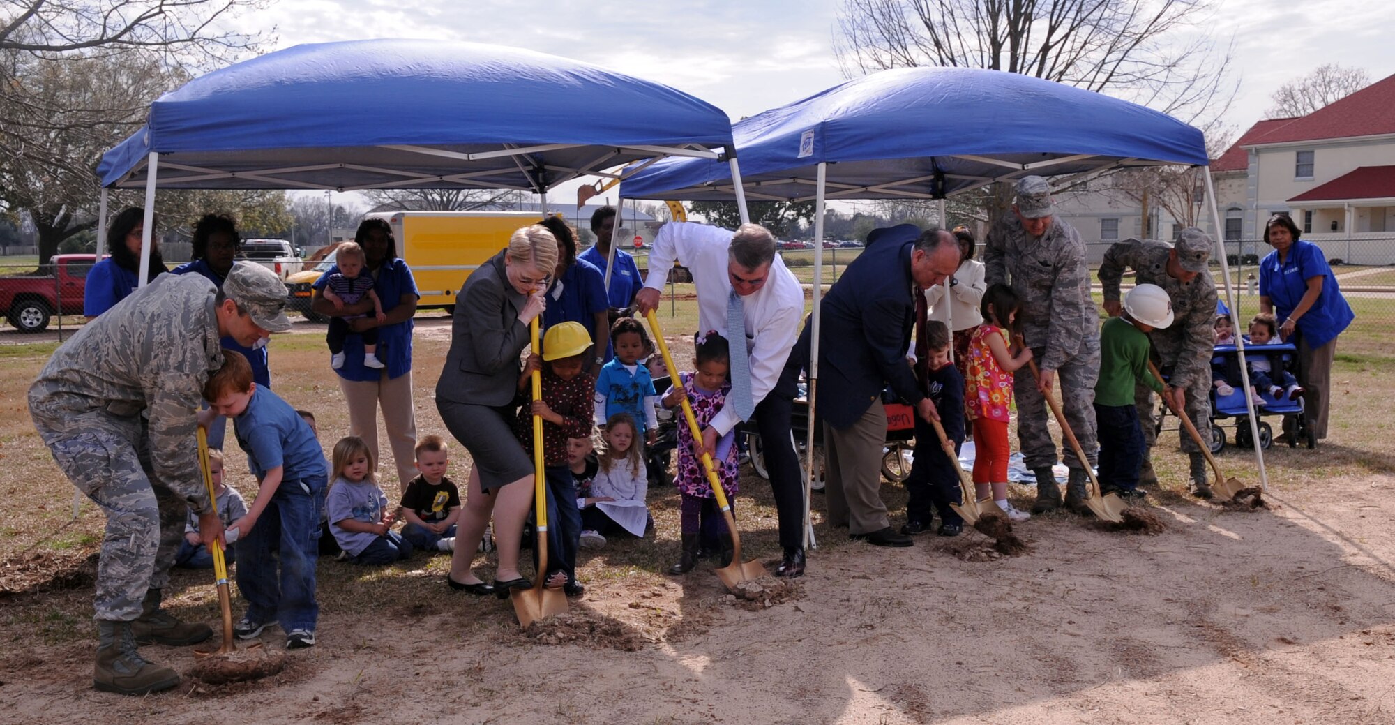 BARKSDALE AIR FORCE BASE, La. – Barksdale leadership and members of Brown Builders accompanied by children of the Child Development Center break ground for their new building Mar. 8., which will be built adjacent to the old one. (U.S. Air Force photo by Senior Airman La’Shanette V. Garrett) (RELEASED)
