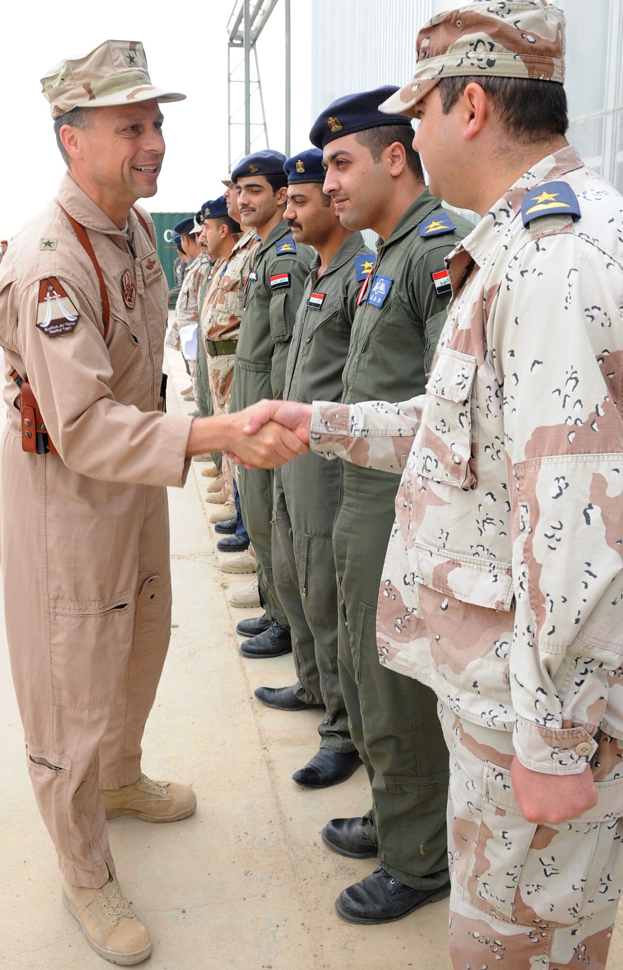 Brig. Gen. Scott Hanson, 321st Air Expeditionary Wing commander, greets members of the Iraq Training and Advisory Mission-U.S. Air Force and the Iraqi air force following the formal transfer to the Iraqis of a newly restored hangar at Kirkuk Regional Air Base, Iraq on March 10, 2010. (U.S. Air Force photo/Staff Sgt. Tabitha Kuykendall)