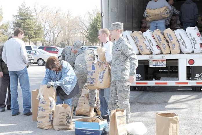 Hill Air Force Base personnel gather at the parking lot near the Airman and Family Readiness Center on March 12 to work as volunteers at the potato drop off or to take a bag of potatoes home to make use of them. 