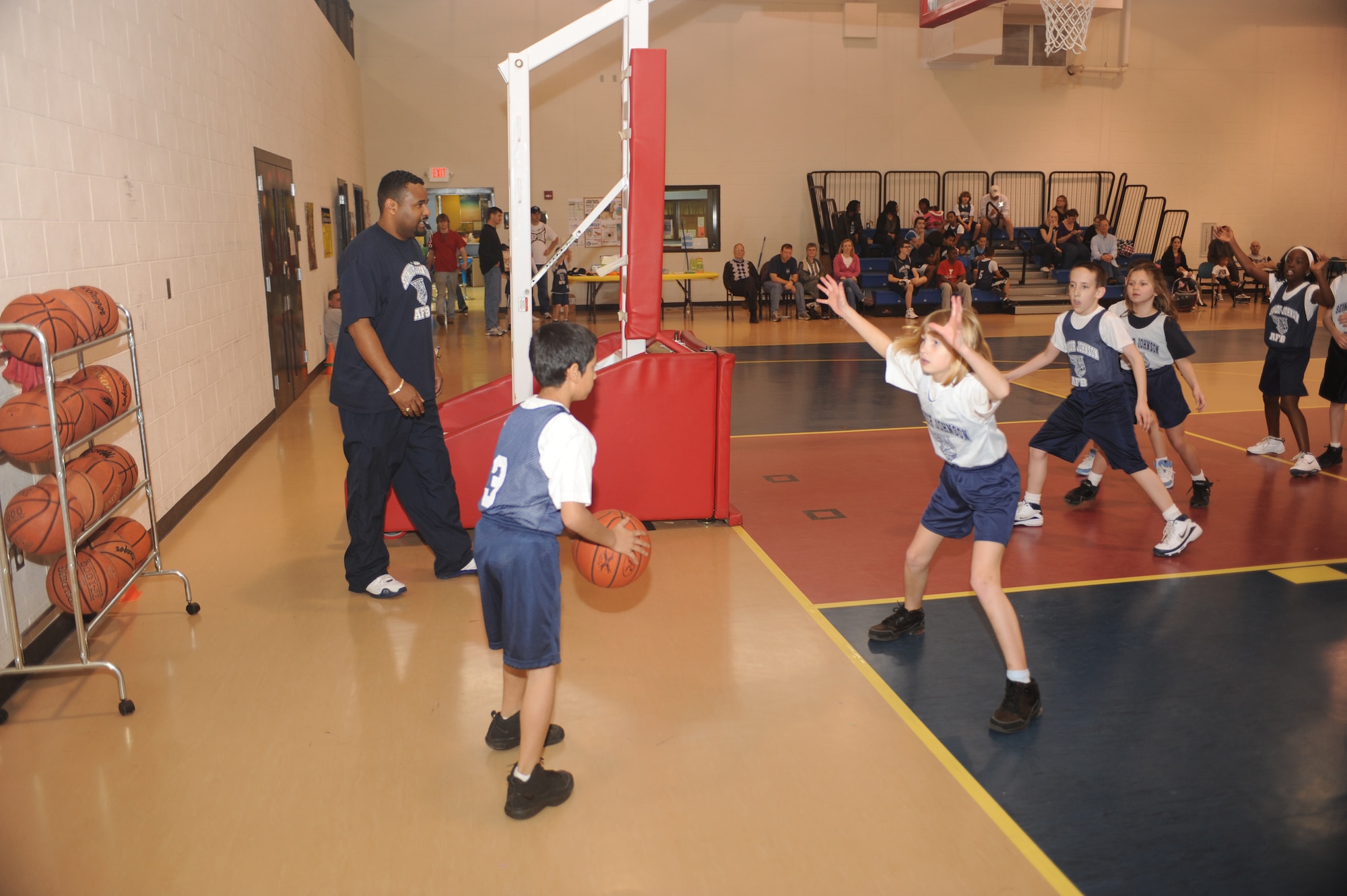 Courtney Andrews, Sharks forward, defends an in-bounds pass from Carlos Lane, Wolves guard, during a 9-to 10-year-old end-of-season basketball game at the youth center on Seymour Johnson Air Force Base, N.C., March 13, 2010.  Courtney is the daughter of Capt. Michael Andrews, 4th Aircraft Maintenance Squadron maintenance operations officer.  Carlos is the son of Staff Sgt. Rico Lane, 4th Contracting Squadron contracting administer.  (U.S. Air Force photo/Tech. Sgt. Lesley Waters)