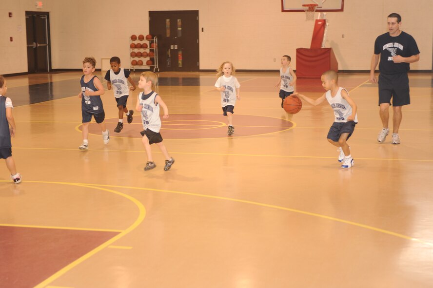 Terrence Hampton, Bulls center, dribbles the ball down the court during a 5-to 6-year-old end-of-season basketball game at the youth center on Seymour Johnson Air Force Base, N.C., March 13, 2010.  Terrence is the son of Master Sgt. Lafaunta Hampton, 4th Component Maintenance Squadron production superintendent.  (U.S. Air Force photo/Tech. Sgt. Lesley Waters)