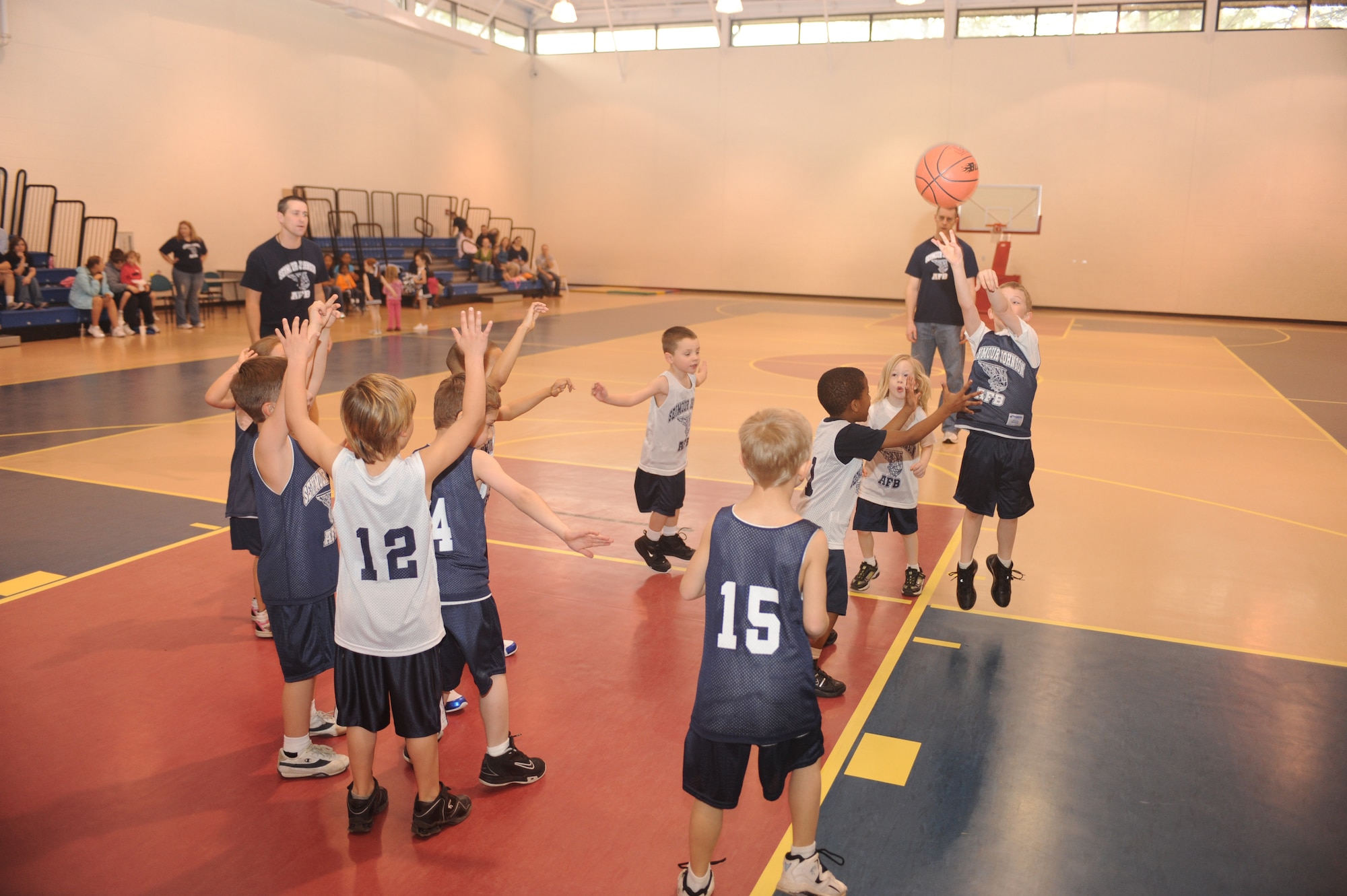 Landry Waters, Fighting Dragons center, shoots over Jaiden Bradley, Bulls guard, during a 5-to 6-year-old end-of-season basketball game at the youth center on Seymour Johnson Air Force Base, N.C., March 13, 2010.  The Fighting Dragons and Bulls are part of the Seymour Johnson youth basketball program and competed against teams from the Boys and Girls Club, YMCA, Wayne Country Day School, Woodman of the World, Eureka, Northeast and Northwest. Landry is the son of Tech. Sgt. Lesley Waters, 4th Fighter Wing Public Affairs internal information noncommissioned officer in charge.  Jaiden is the son of Staff Sgt. Jerrick Bradley, 336th Aircraft Maintenance Squadron avionics specialist.  (U.S. Air Force photo/Tech. Sgt. Lesley Waters)