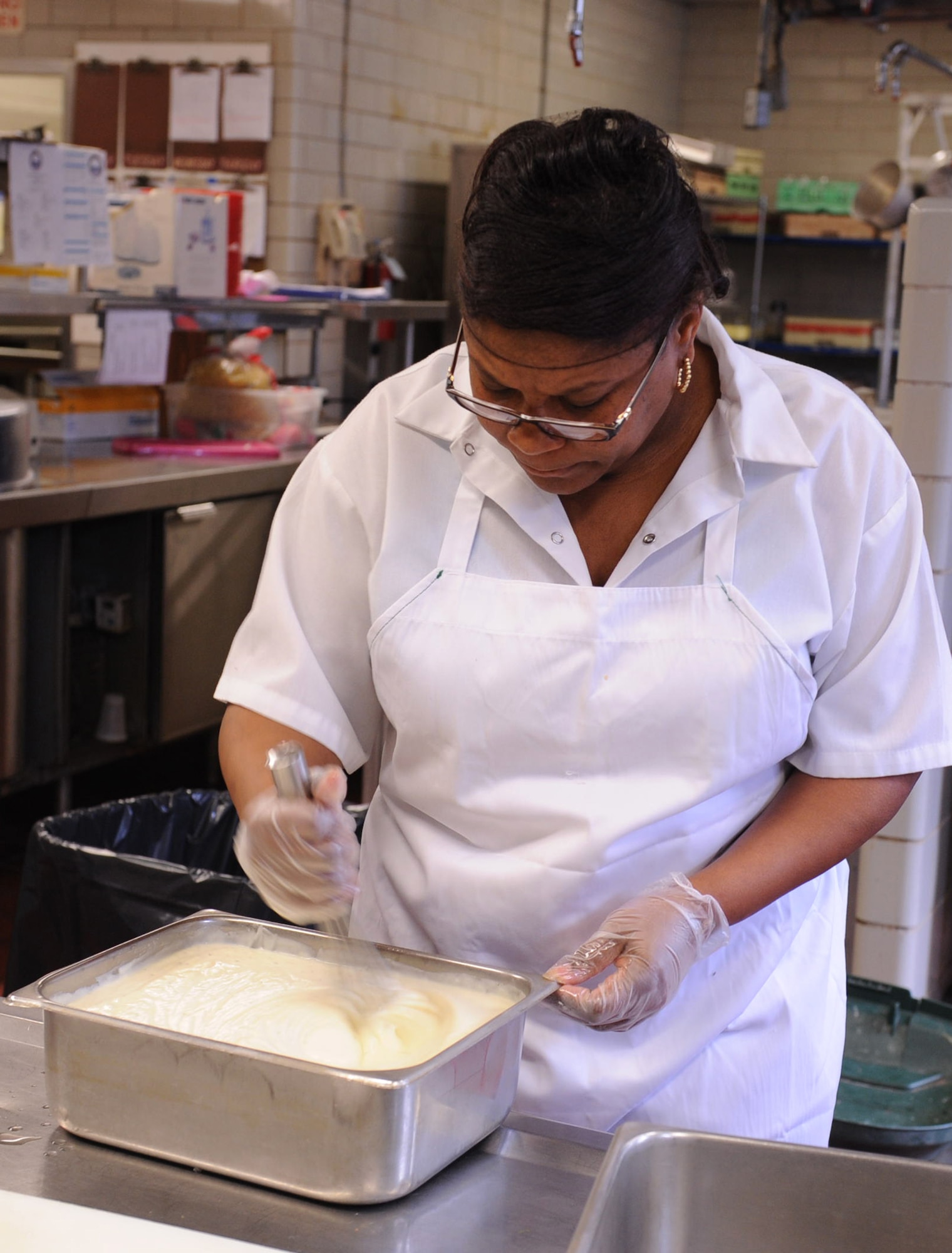 Beverly Urquhart, Simply Seymour's Too cook, stirs alfredo sauce before placing it on the restaurant's lunch buffet line on Seymour Johnson Air Force Base N.C., March 18, 2010. Diners indulging on the all-you-can-eat Italian buffet can enjoy marinara or alfredo sauce on penne or linguine noodles. Urquhart is from Goldsboro, N.C. (U.S. Air Force photo/ Senior Airman Whitney Lambert)