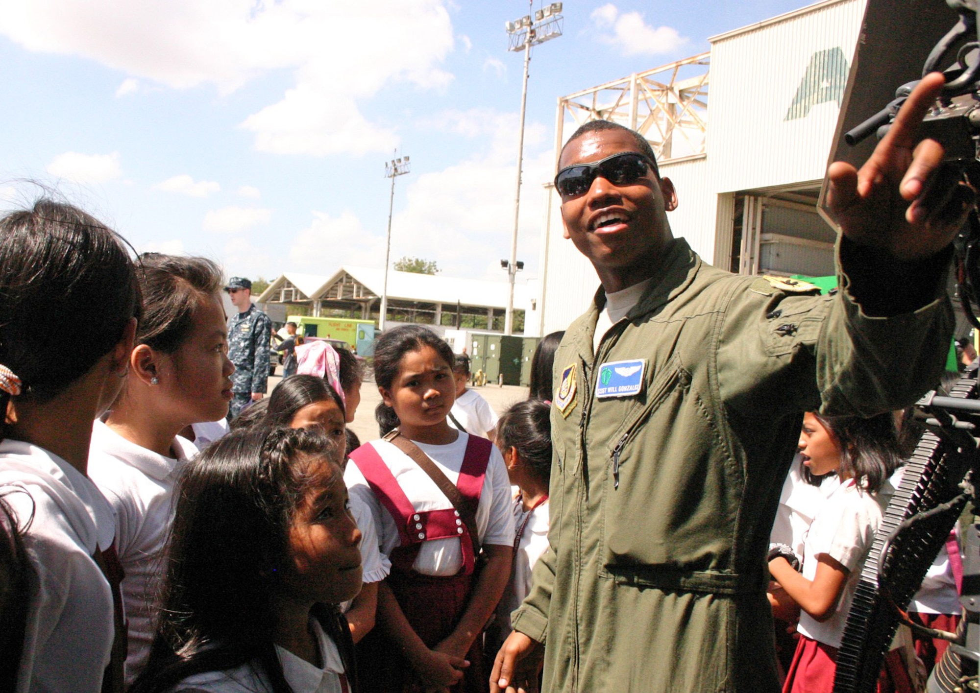 Staff Sgt. Will Gonzalez talks about the HH-60G Pave Hawk with Philippine students during their visit to the flightline March 15, 2010, at Freeport Clark, Philippines. Sergeant Gonzalez is assigned to the 33rd Rescue Squadron at Kadena Air Base, Japan. (U.S. Marine Corps photo/Gunnery Sgt. Cindy Fisher)