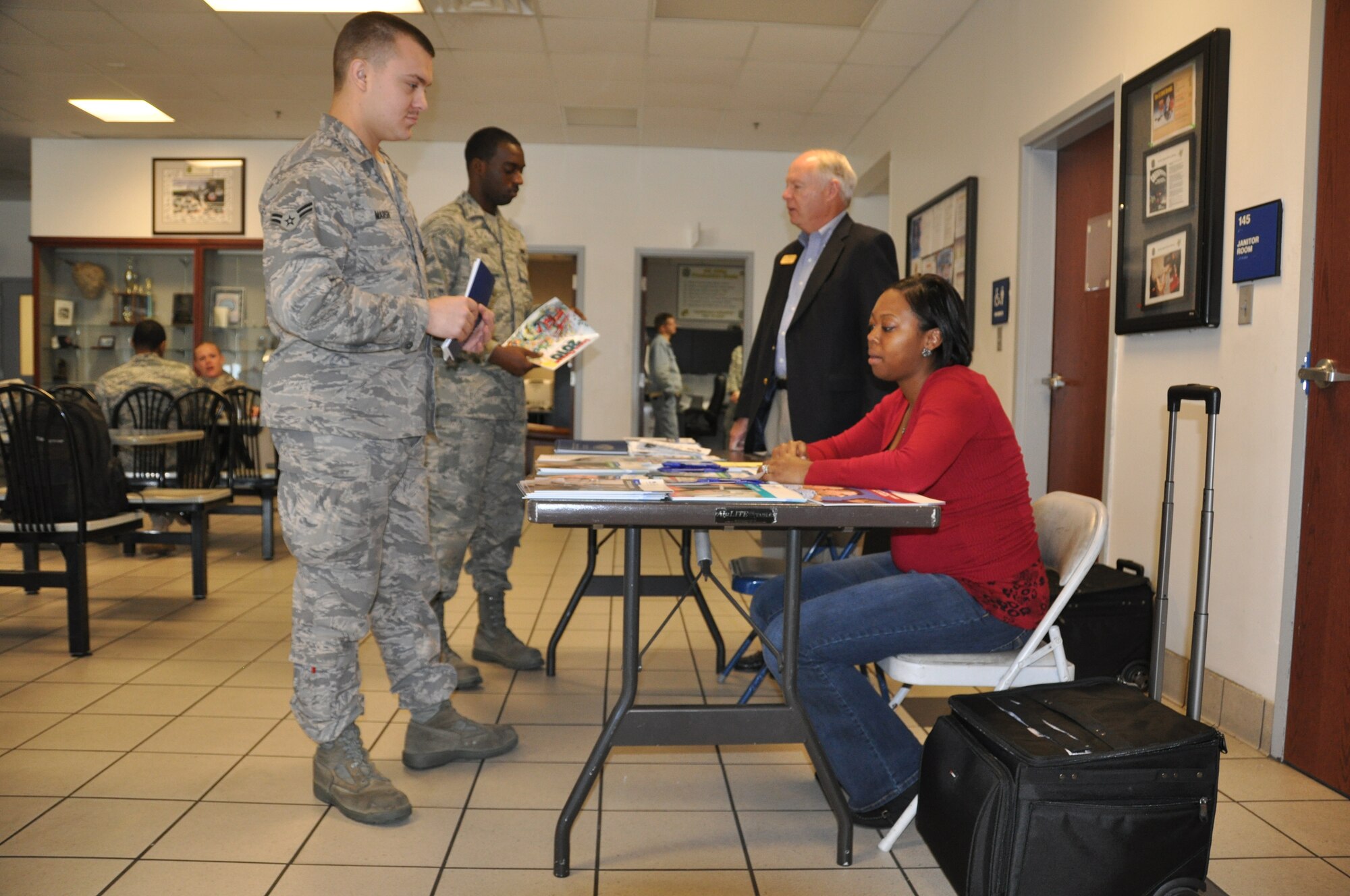 Jim Harkey, Military Family Life counselor, and Latoya Reese, Airman and Family Readiness work life specialist, speak with Airmen at the 43rd Air Maintenance Unit about financial issues during the Military Saves Campaign.  (U.S. Air Force photo/Senior Airman Veronica McMahon)