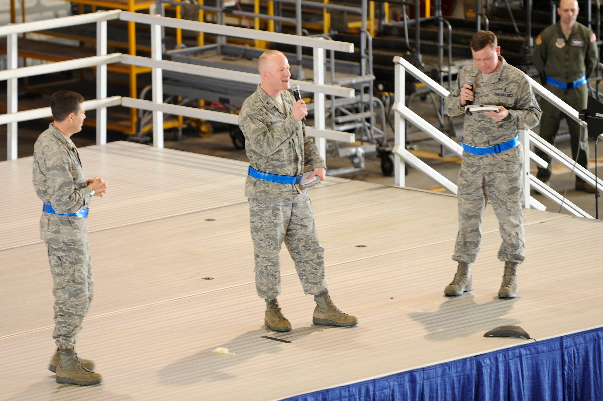 SCOTT AIR FORCE BASE, Ill – Col. Gary Goldstone, 375th Air Mobility Wing commander, along with Chief Master Sgt. James Suttles, 375th AMW command chief, and Col. Stephen Oliver, 375th AMW vice commander, speak to members of the 375th AMW during a wing all call held inside Hangar 1 at Scott, March 19, 2010. The all call was held to fire up the wing in preparation for the Operational Readiness Inspection March 21 through 27. (U.S. Air Force photo/ Senior Airman Wesley Farnsworth)