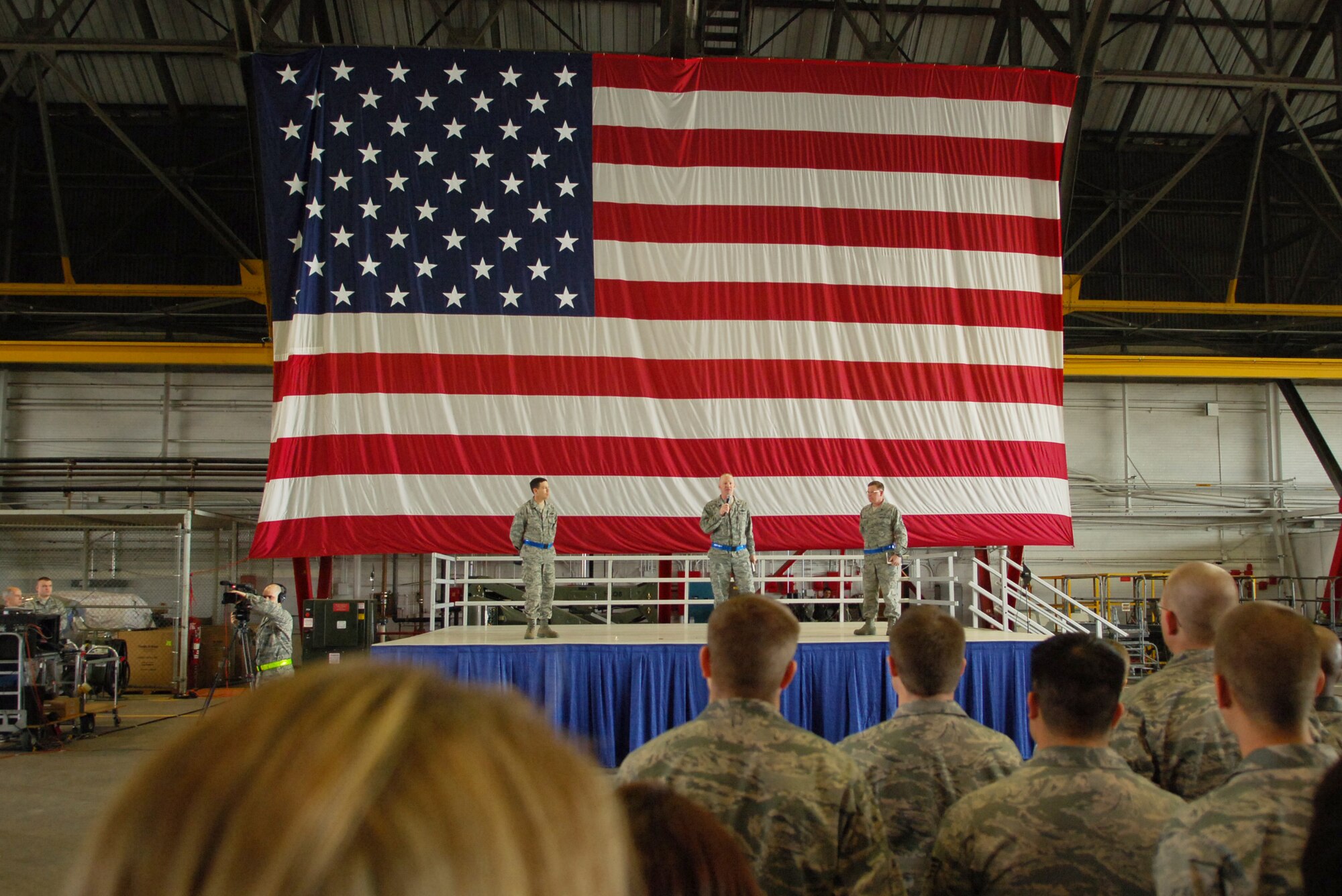 SCOTT AIR FORCE BASE, Ill. – Col. Gary Goldstone, 375th Air Mobility Wing commander, speaks to more than 1,500 Airmen encouraging them to be “outstanding” during the upcoming Operational Readiness Inspection while Chief Master Sgt. James Suttles, 375th AMW command chief and Col. Stephen Oliver, 375th AMW vice commander, looks on, March 19, 2010. (U.S. Air Force photo/ Senior Airman Ryan Crane)