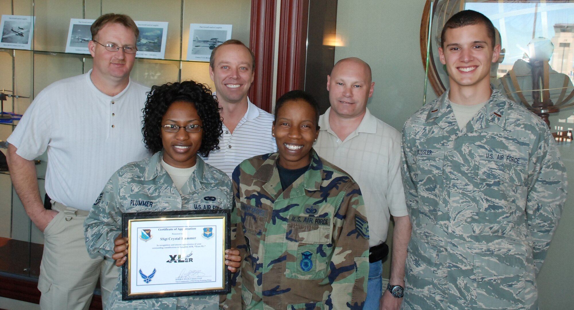 LAUGHLIN AIR FORCE BASE, Texas – Staff Sgt. Crystal Plummer, 47th Flying Training Wing Plans and Programs, poses with fellow members of her squadron after being presented the XLer of the Week award by Col. David Ellis, 47th Flying Training Wing vice commander, here March 10. (U.S. Air Force photo by Airman 1st Class Blake Mize)
