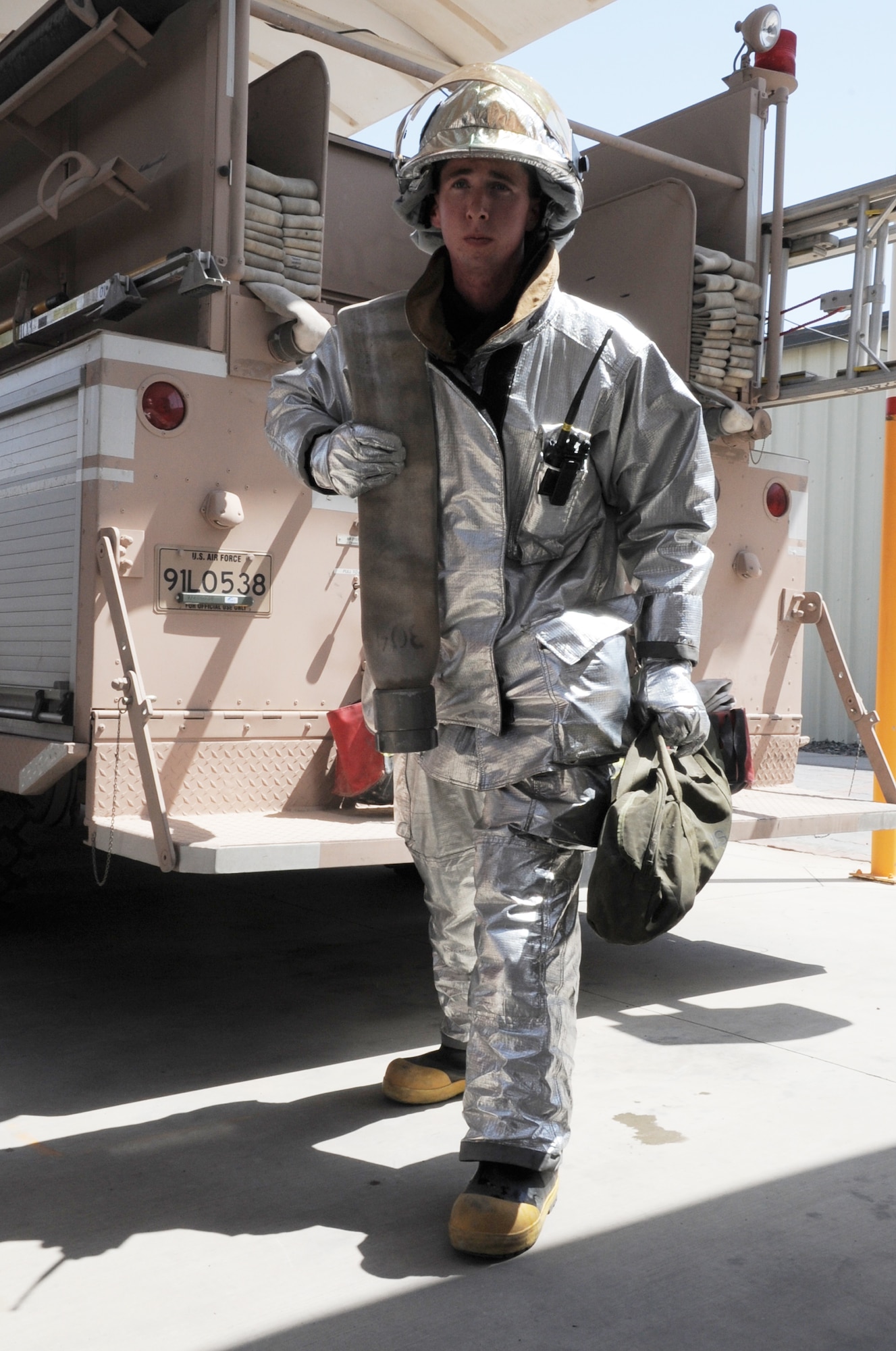 Airman 1st Class Samuel Siewert, firefighter with the 380th Expeditionary Civil Engineer Squadron fire department, moves equipment from a fire truck training during operations at a non-disclosed base in Southwest Asia on March 14, 2010. As an Air Force firefighter, Airman Siewert and his fellow firefighters are responsible for protecting thousands of deployed personnel and billions of dollars of Air Force assets from fire. He is deployed from the 628th Civil Engineer Squadron fire department at Joint Base Charleston, S.C., and his hometown is Oconomowoc, Wisc. (U.S. Air Force Photo/Master Sgt. Scott T. Sturkol)