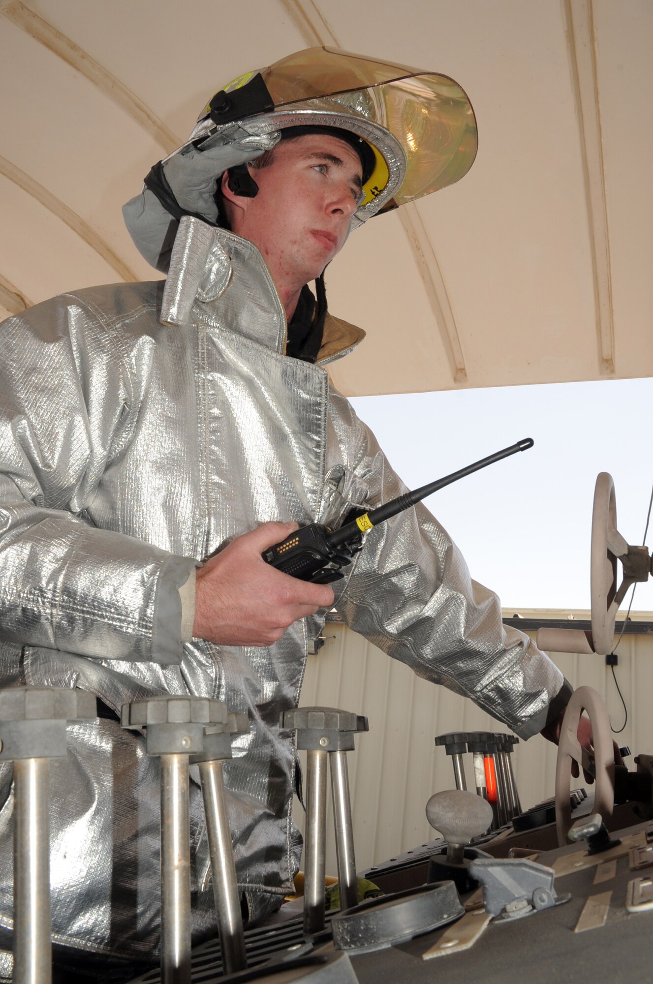 Airman 1st Class Samuel Siewert, firefighter with the 380th Expeditionary Civil Engineer Squadron fire department, tests the controls on a fire truck for training during operations at a non-disclosed base in Southwest Asia on March 14, 2010. As an Air Force firefighter, Airman Siewert and his fellow firefighters are responsible for protecting thousands of deployed personnel and billions of dollars of Air Force assets from fire. He is deployed from the 628th Civil Engineer Squadron fire department at Joint Base Charleston, S.C., and his hometown is Oconomowoc, Wisc. (U.S. Air Force Photo/Master Sgt. Scott T. Sturkol)