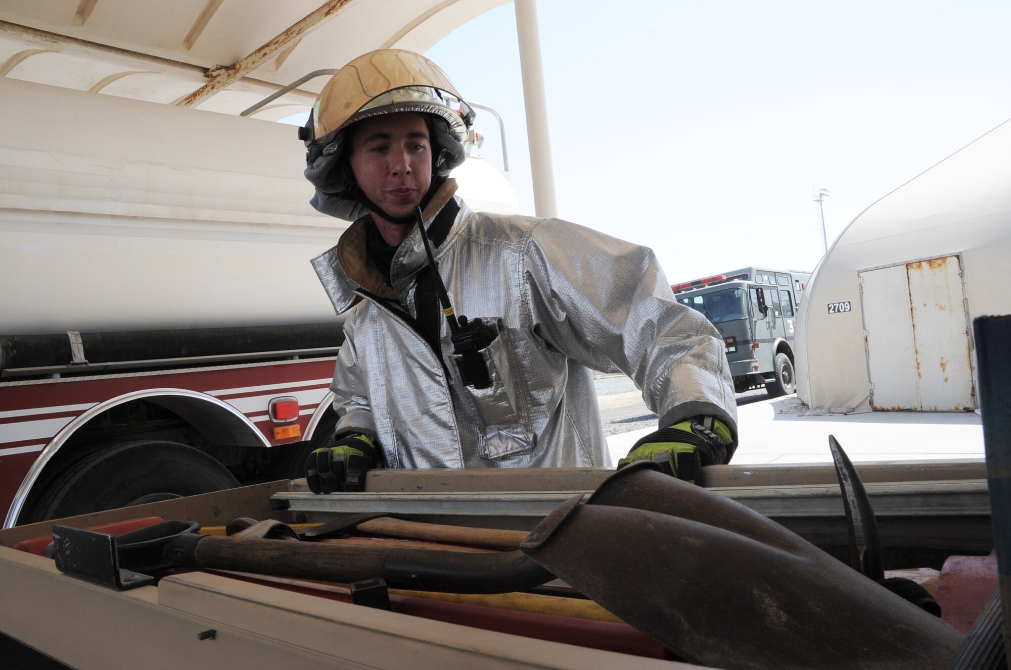 Airman 1st Class Samuel Siewert, firefighter with the 380th Expeditionary Civil Engineer Squadron fire department, removes equipment from a fire truck for training during operations at a non-disclosed base in Southwest Asia on March 14, 2010. As an Air Force firefighter, Airman Siewert and his fellow firefighters are responsible for protecting thousands of deployed personnel and billions of dollars of Air Force assets from fire. He is deployed from the 628th Civil Engineer Squadron fire department at Joint Base Charleston, S.C., and his hometown is Oconomowoc, Wisc. (U.S. Air Force Photo/Master Sgt. Scott T. Sturkol)