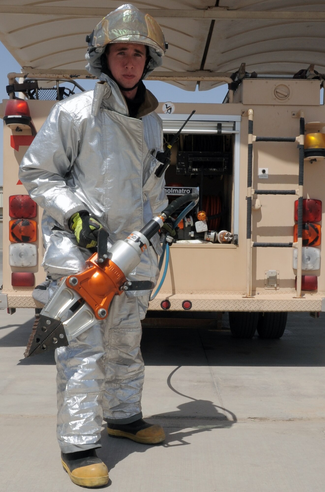 Airman 1st Class Samuel Siewert, firefighter with the 380th Expeditionary Civil Engineer Squadron fire department, moves out a "jaws of life" for training during operations at a non-disclosed base in Southwest Asia on March 14, 2010. As an Air Force firefighter, Airman Siewert and his fellow firefighters are responsible for protecting thousands of deployed personnel and billions of dollars of Air Force assets from fire. He is deployed from the 628th Civil Engineer Squadron fire department at Joint Base Charleston, S.C., and his hometown is Oconomowoc, Wisc. (U.S. Air Force Photo/Master Sgt. Scott T. Sturkol)