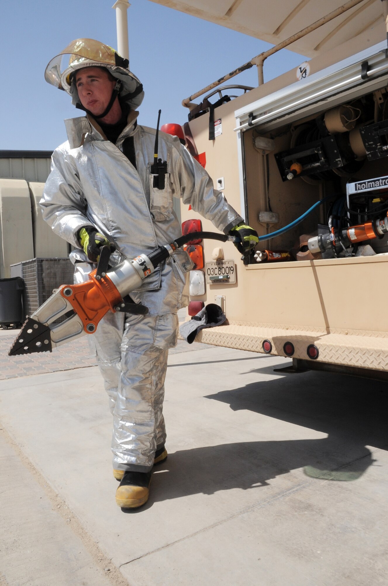 Airman 1st Class Samuel Siewert, firefighter with the 380th Expeditionary Civil Engineer Squadron fire department, moves out a "jaws of life" for training during operations at a non-disclosed base in Southwest Asia on March 14, 2010. As an Air Force firefighter, Airman Siewert and his fellow firefighters are responsible for protecting thousands of deployed personnel and billions of dollars of Air Force assets from fire. He is deployed from the 628th Civil Engineer Squadron fire department at Joint Base Charleston, S.C., and his hometown is Oconomowoc, Wisc. (U.S. Air Force Photo/Master Sgt. Scott T. Sturkol)