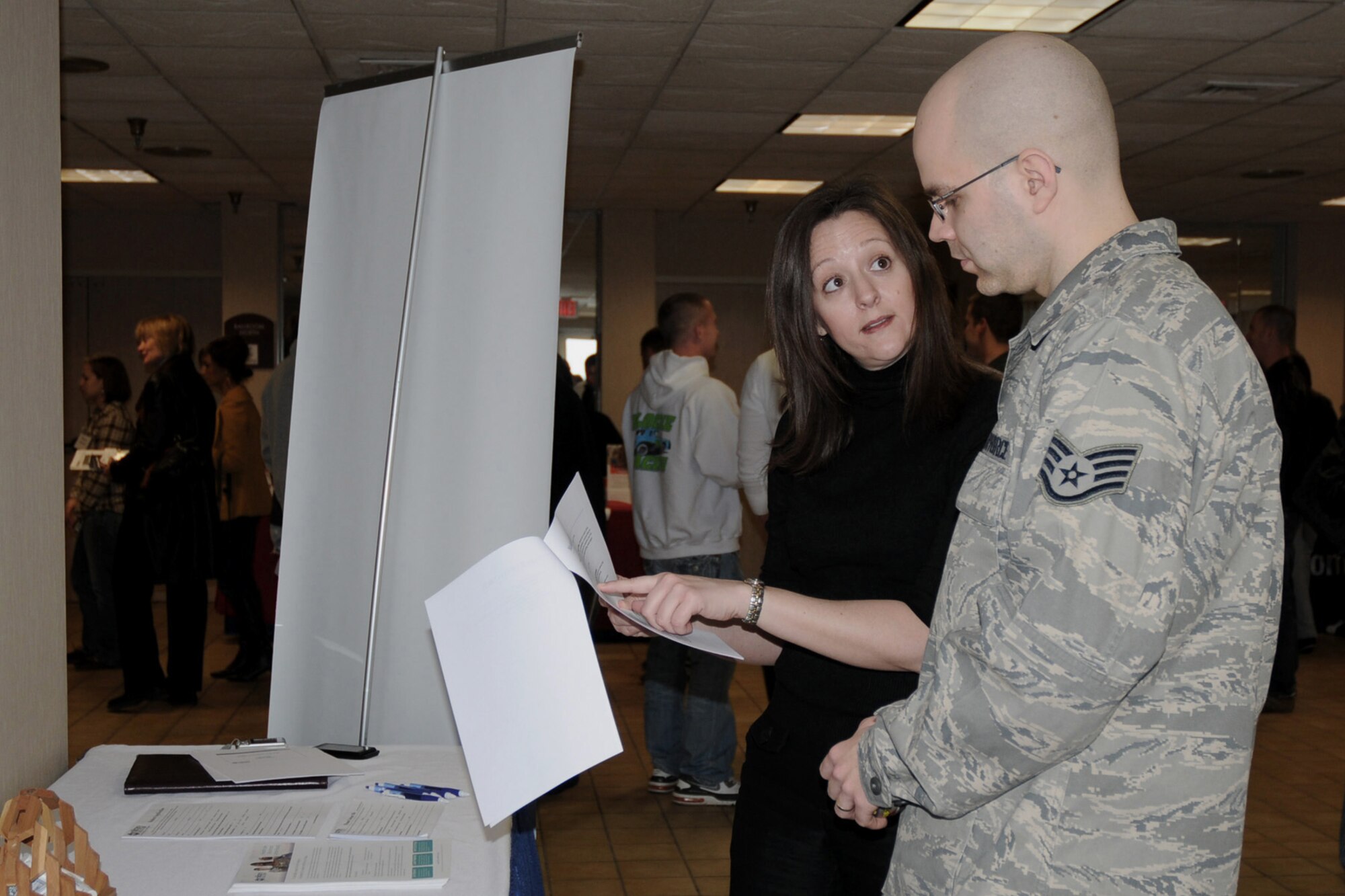 Staff Sgt. Taylor York (right) listens intently as Military Medicine (M2M) representative Heidi Carter (left) reviews information with him about what the M2M program has to offer.  Sgt. York recently returned from deployment and is attending the Yellow Ribbon Event being held at the Holiday Inn Airport in Des Moines, Iowa on March 6, 2010.  (US Air Force photo/Staff Sgt. Linda E. Kephart)(Released)