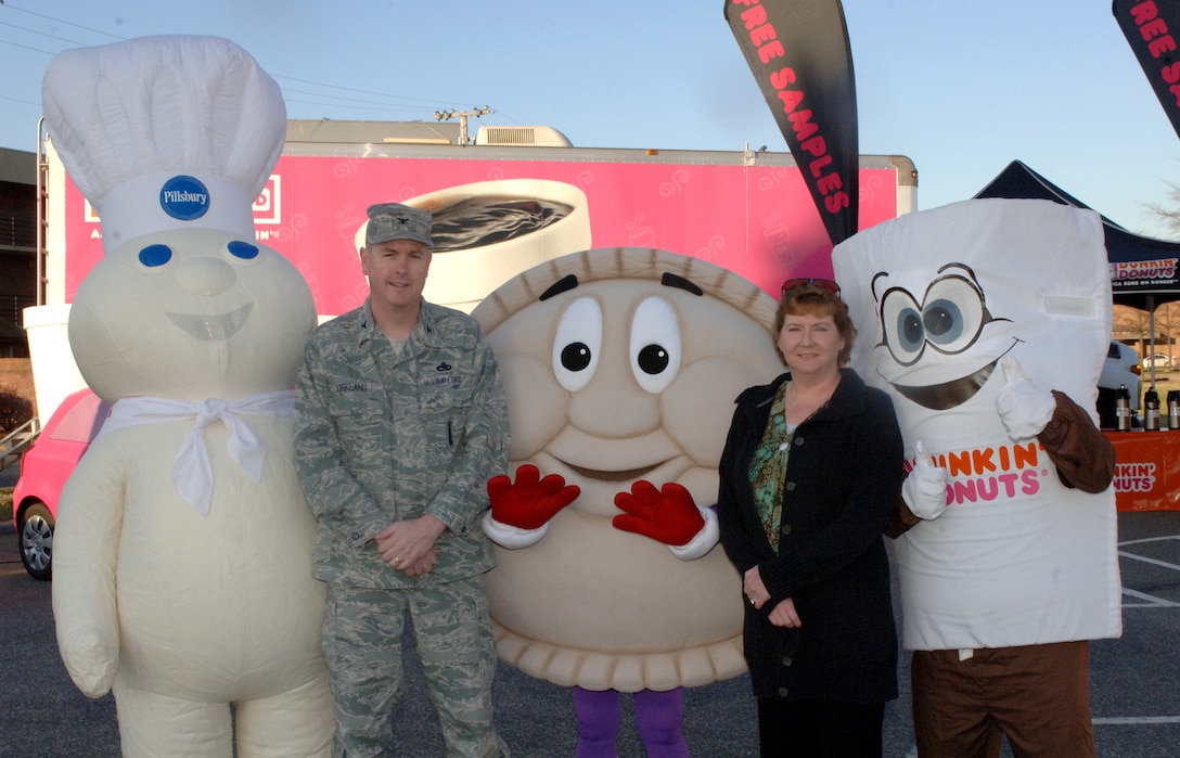 LANGLEY AIR FORCE BASE, Va. – Col. Donald Kirkland, 633d Air Base Wing commander, and his wife, Judy, pose with mascots at the Smucker's Mission: Breakfast celebration March 19. Smucker's provided free breakfast to military personnel and their families to reward the Langley Commissary for winning the Mission: Breakfast contest for most unique store display. (U.S. Air Force photo/Airman 1st Class Jason J. Brown)