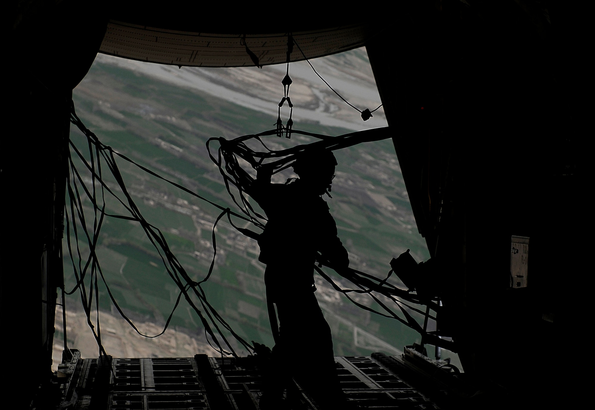 Senior Master Sgt. Thomas Kelly retrieves straps after an airdrop over Afghanistan March 2, 2010. Sergeant Kelly is deployed from the Rhode Island National Guard's 135th Airlift Squadron, and is from Baltimore, Md.  (U.S. Air Force photo/Tech. Sgt. Jeromy K. Cross)




