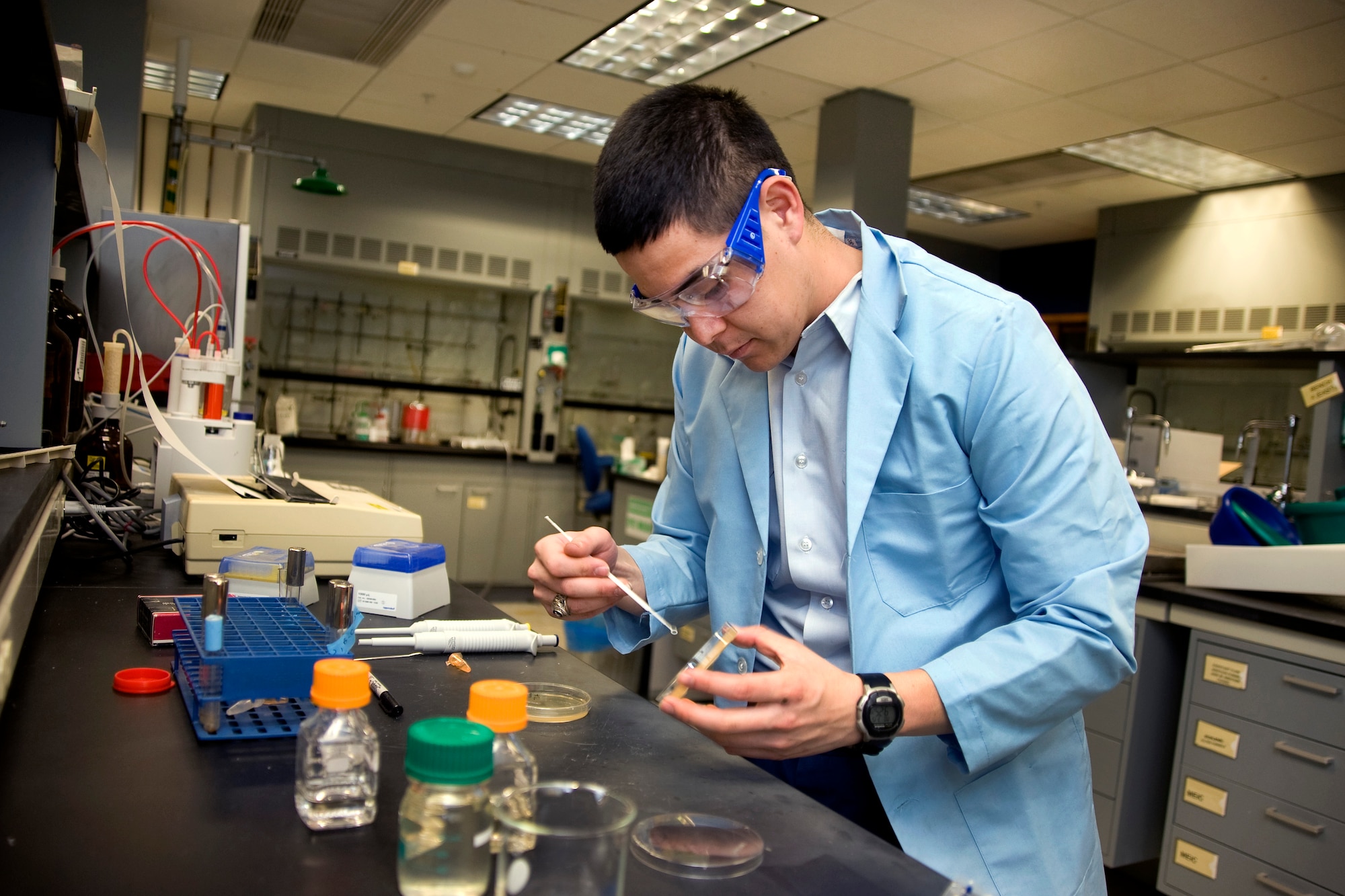 Air Force Academy Cadet 1st Class Chris Horn examines an ionic liquid in a chemistry laboratory at the Academy March 15, 2010. The Academy is developing a fast, environmentally friendly method to neutralize chemical warfare agents such as sarin and VX using certain ionic liquids. Cadet Horn and Cadet 1st Class Joe Lewczyk are also conducting follow-on research with ionic liquids to determine whether the room-temperature molten salts can neutralize certain biological agents. (U.S. Air Force photo/Johnny Wilson)