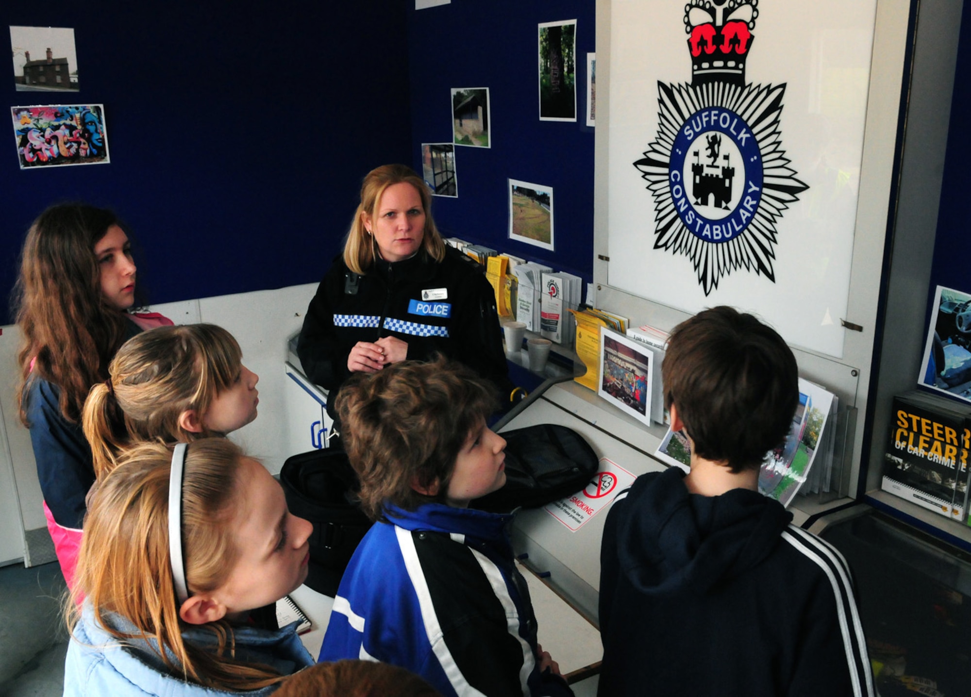 Police Constable Vicky McNamara, Suffolk Police, talks to children from Liberty Intermediate School, RAF Lakenheath, about criminal damage, discussing what it is and its effects. The scenario was part of a week-long Crucial Crew event for children from local middle schools and the base's intermediate school, held at Mildenhall stadium in West Row. The event was organized by Forest Heath crime prevention panel, and gives children the opportunity to experience eight different scenarios, including how to make a 999 emergency call, fire safety and Internet safety. Nine volunteers from RAF Mildenhall helped at the event throughout the week.  (U.S. Air Force photo/Karen Abeyasekere)