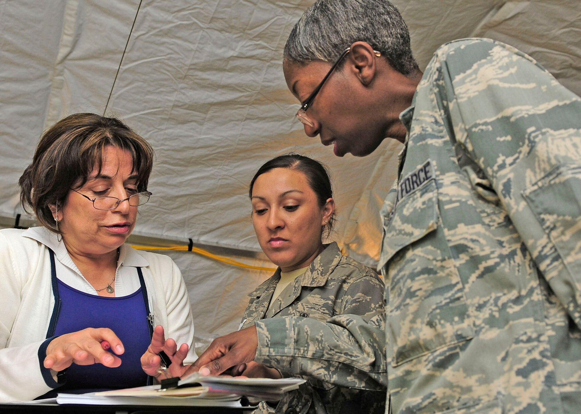 Senior Airman Cassondra Johnson (center) translates a conversation between a Chilean nurse and Maj. Sharon Walker March 17, 2010, in Angol, Chile. Airman Johnson is a aerospace medical technician assigned to the 81st Aerospace Medical Squadron at Keesler Air Force Base, Miss. Major Walker is the chief nurse of expeditionary hospital here and is deployed from Keesler Air Force Base, Miss. (U.S. Air Force photo/Senior Airman Tiffany Trojca)
