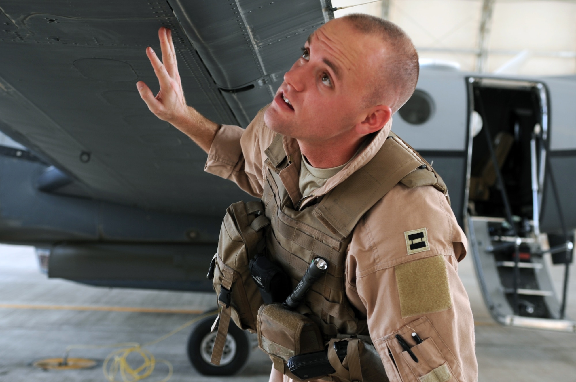 Capt. Ryan Woodman, a pilot with the 362nd Expeditionary Reconnaissance Squadron, visually inspects an MC-12 Liberty prior to flight at Joint Base Balad, Iraq, March 11, 2010. The MC-12 is a tactical intelligence, surveillance and reconnaissance aircraft that allows its crew to support ground troops. (U.S. Air Force photo/Senior Airman Brittany Y. Bateman/Released)
