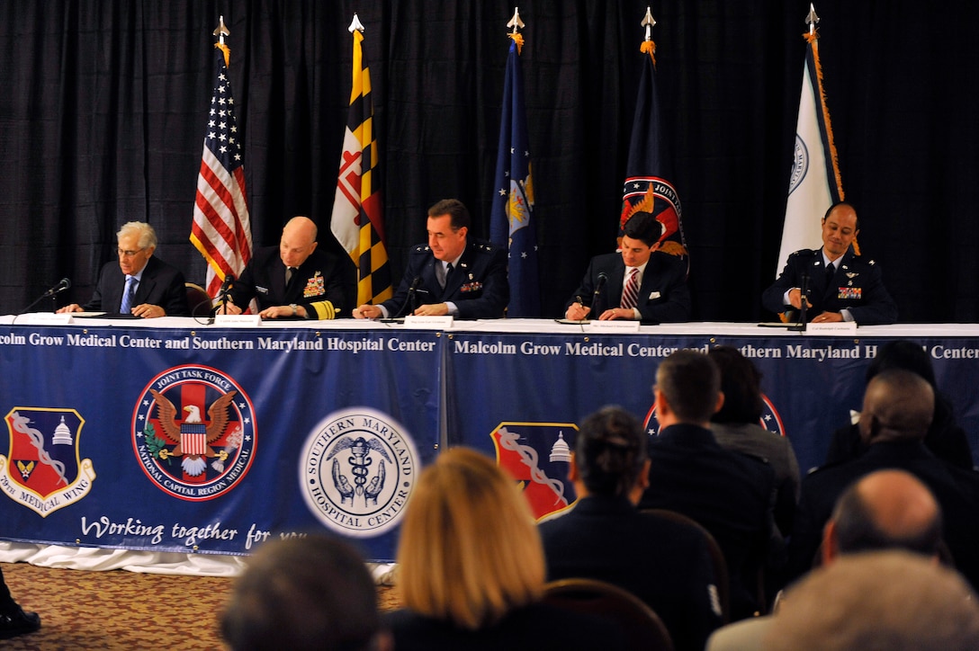 From left to right: Francis P. Chiaramonte, president and chairman of the board for Southern Maryland Hospital; Vice Admiral John Mateczun, commander Joint Task Force of the National Capital Area; Maj. Gen. Gar Graham, commander 79th Medical Wing; Michael Chiaramonte, chief executive officer of SMHC; and Col. Rudolph Cachuela, commander of the 779th Medical Group sign the partnership agreement forms during a signing ceremony at Colony South in Clinton, Md., on Mar. 18, 2010. Malcolm Grow Medical Center recently transferred all of their labor and delivery services to SMHC, which is located less than ten minutes from the Virginia Gate at Joint Base Andrews, Md., as a part of the BRAC realignment process. (U.S. Air Force photo by Staff Sgt. Renae L. Saylock)