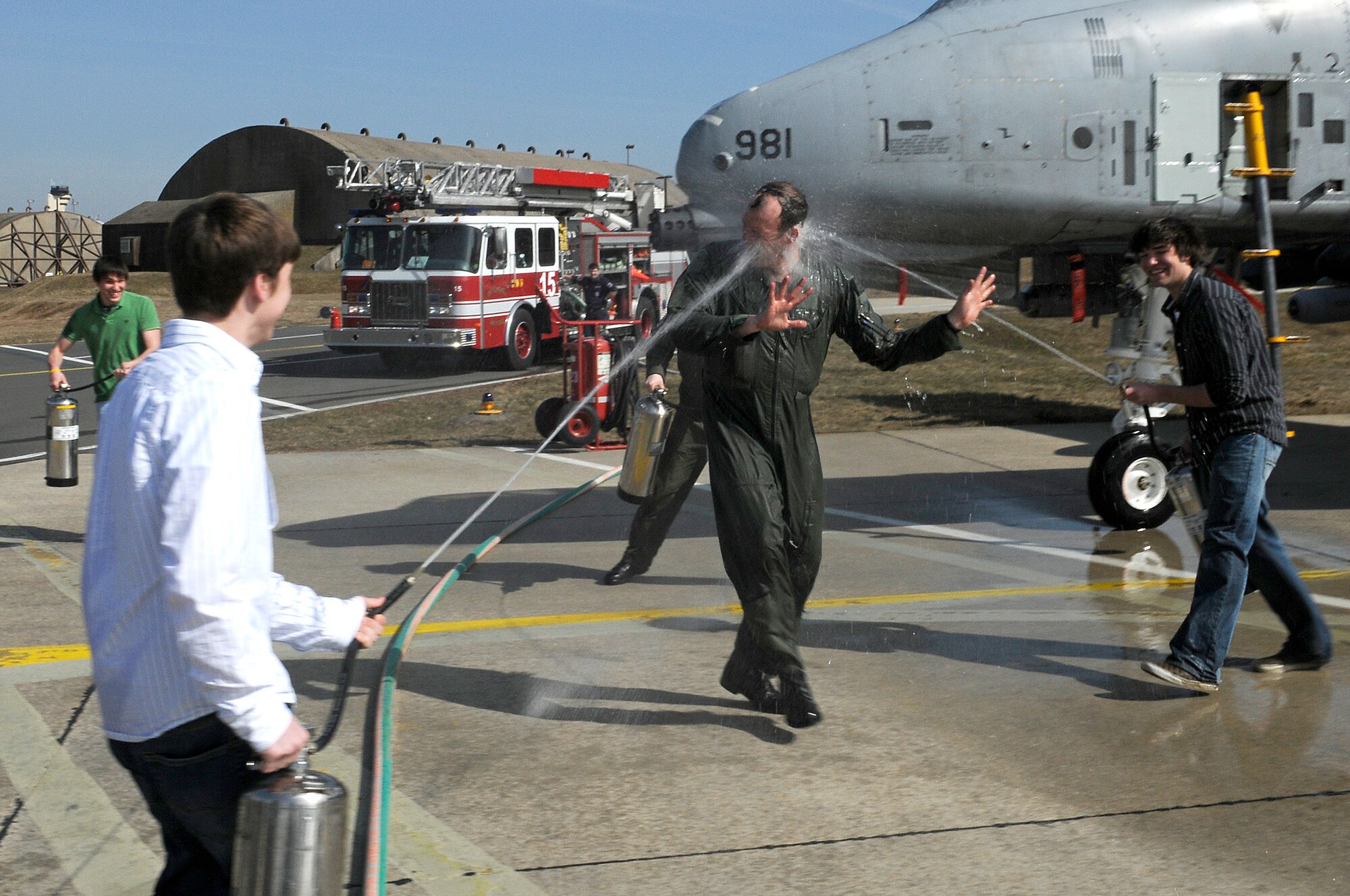 SPANGDAHLEM AIR BASE, Germany – Friends and family of Lt. Col. Joseph Less, 52nd Operations Group deputy commander, spray him with water on the flightline after his final flight as a member of the U.S. Air Force March 18. Colonel Less has flown more than 3,800 hours with the Air Force since becoming a pilot in 1988. (U.S. Air Force photo/Senior Airman Benjamin Wilson)
