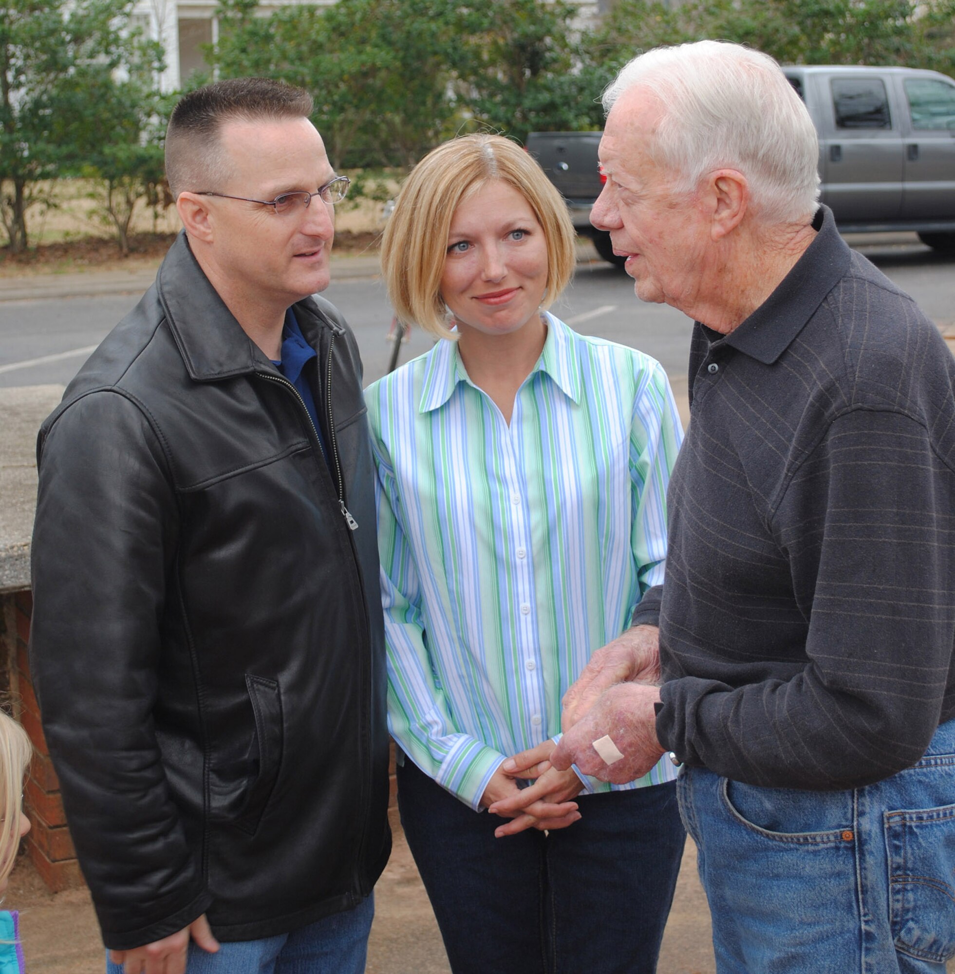 Chief Master Sergeant Harold "Buddy" Hutchison, 78th Air Base Wing command chief, and his wife Tonya, meet  and talk with President Jimmy Carter during a stop in Plains on the Airman and Family Readiness Center train trip for Robins' deployed family members. U. S. Air Force photo by Tech. Sgt. Vann Miller