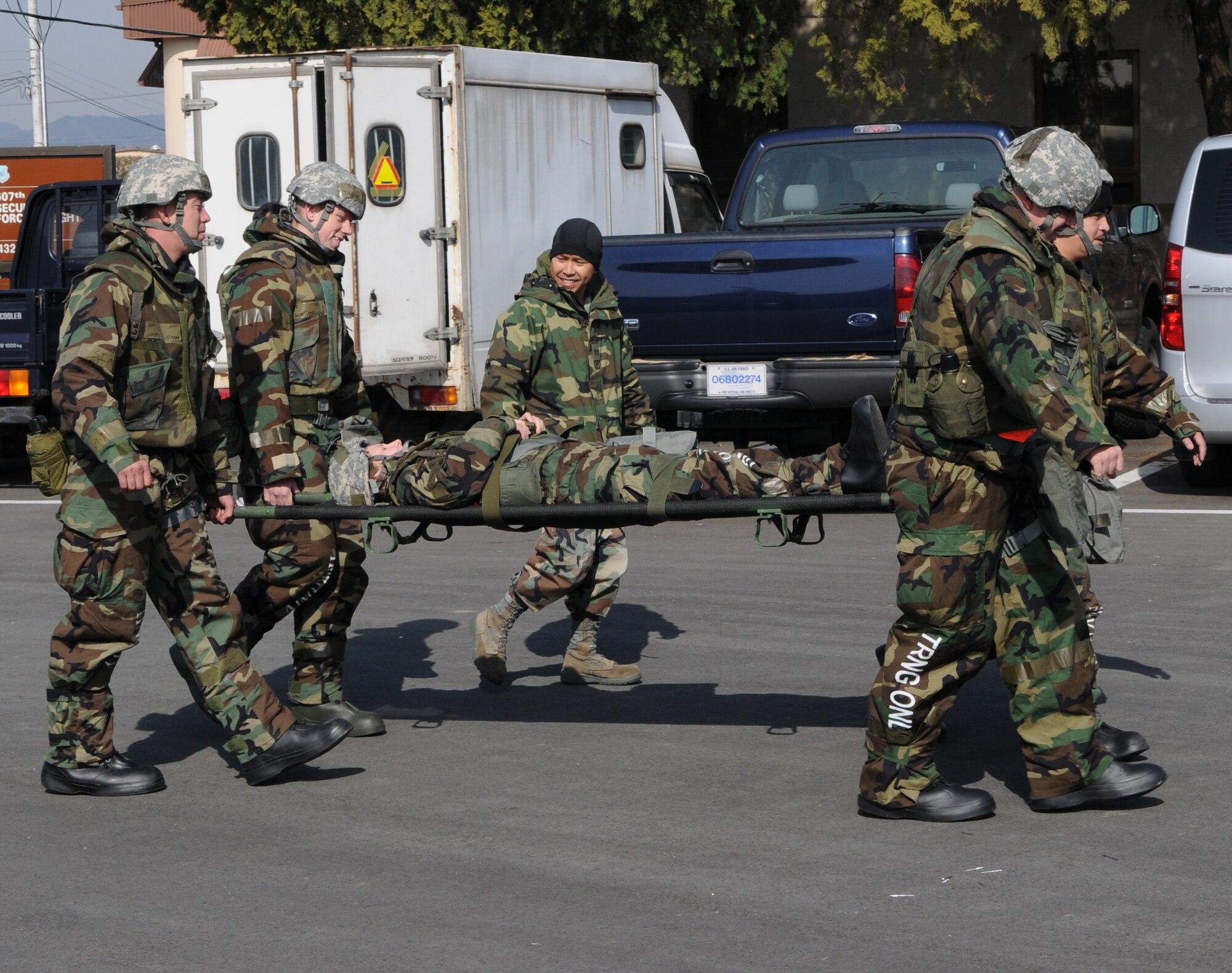 DAEGU AIR BASE, Republic of Korea -- Tech. Sgt. Jose Llanes (on stretcher), from the 353rd Operations Support Squadron Medical Flight, instructs members of the 353rd Special Operations Group on how to properly carry a patient on a stretcher during training here March 19. The training is in preparation for the group's annual operational readiness exercise which affords unit members an opportunity to practice wartime skills necessary for their ability to survive and operate. (U.S. Air Force photo by Tech. Sgt. Aaron Cram)
