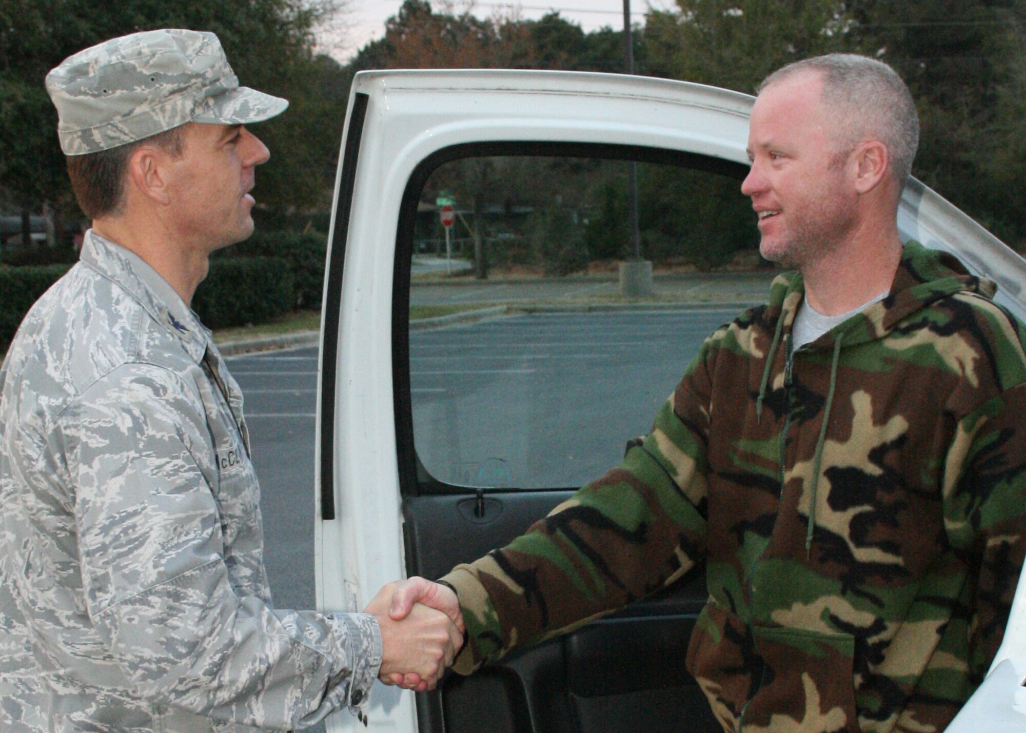 Col. Bruce McClintock, 96th Air Base Wing commander, congratulates Jason Evans on being selected March 18 as the "Hometown Hero" for Eglin's airshow.  Mr. Evans will receive a flight in an Thunderbird F-16 two days before the airshow.  The airshow is April 10,11.  (U.S. Air Force photo/2nd Lt. Andrew Caulk.)
