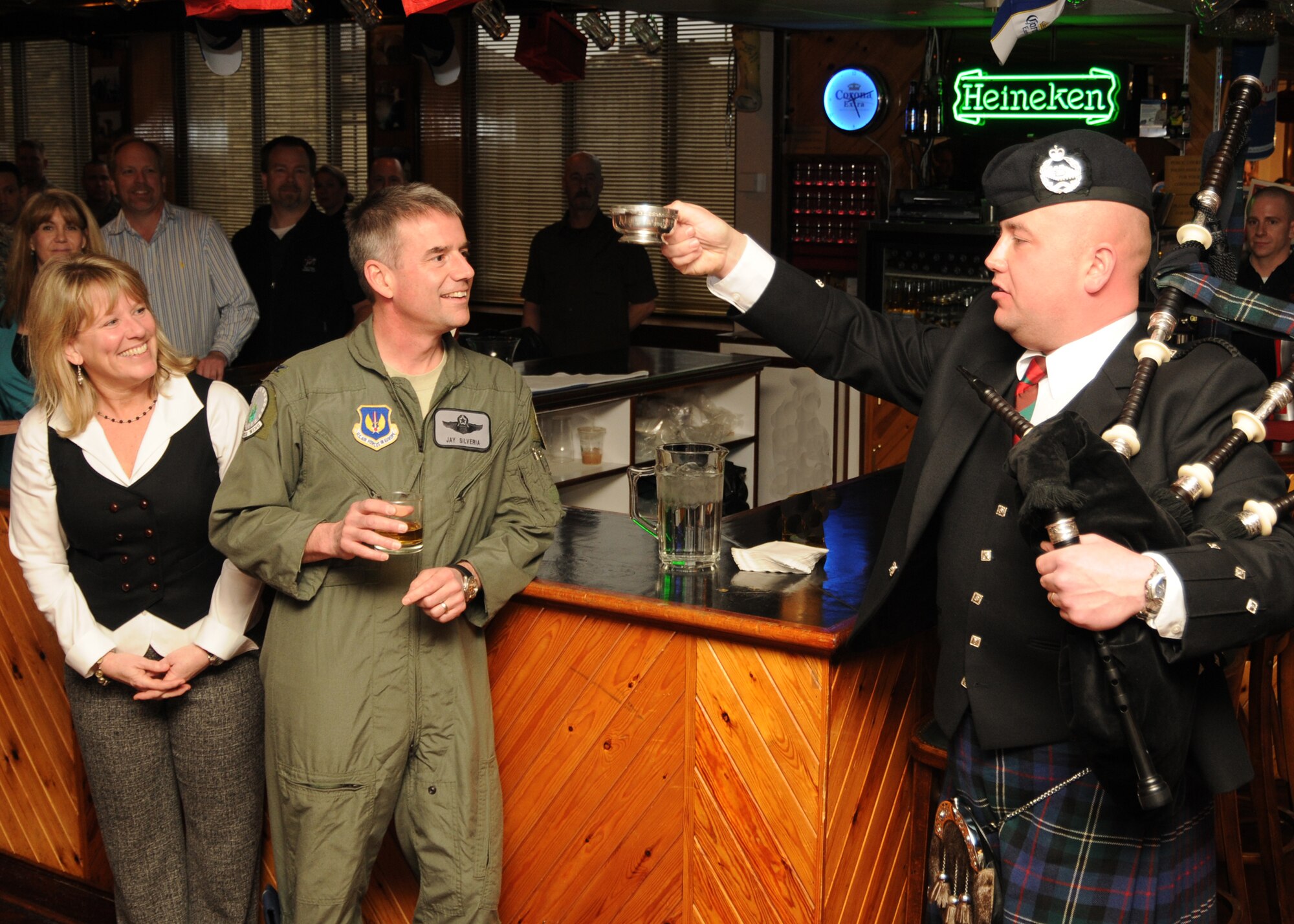 Corporal Jim Douglas of the 1st Royal Tank Regiment, based at RAF Honington,
Suffolk, toasts Col. Jay Silveria and wife Virginia, on his selection for promotion to
brigadier general during a celebration at Eagles Landing on RAF Lakenheath,
England, March 19. 