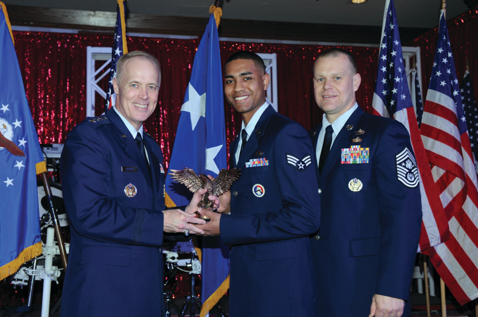 Senior Airman Byran J. Petry, 65th Forces Support Squadron, receives the "2009 Personnel Airman of the Year Award," presented by Lt. Gen. Richard Y. Newton, Deputy Chief of Staff for Manpower and Personnel, along with Chief Master Sgt of the Air Force James A. Roy.  The award was presented March 11 at the 2010 World Wide Force Support Conference Annual Awards Banquet in San Antonio, Texas. (Courtesy photo)