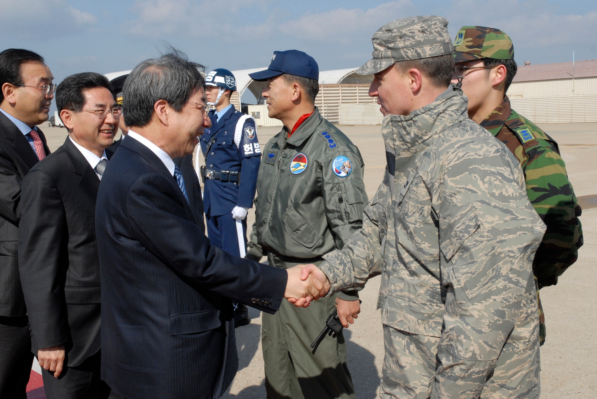 KUNSAN AIR BASE, Republic of Korea -- Mr. Un-chan Chung, Prime Minister of South Korea, greets Col. Robert Givens, commander of the 8th Fighter Wing, during his arrival here March 18. The prime minister met with the governor of Jeonbuk Province and the other city officials and toured the Gunsan area. (U.S. Air Force photo/Staff Sgt. Darnell T. Cannady)