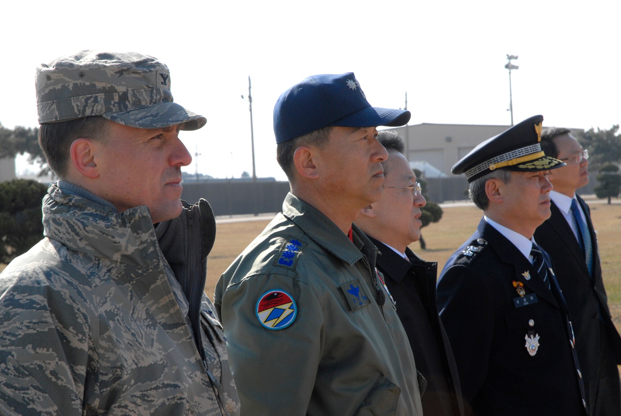 KUNSAN AIR BASE, Republic of Korea -- Col. Robert Givens, commander of the 8th Fighter Wing, Col. Choi, Jae Hun, commander of the 38th Fighter Group, Mr. Wan-ju Kim, Governor of Jeonbuk Province and Mr. Son, Chang Wan, chief of Jeonbuk Provincial Police Agency, await the arrival of  Mr. Un-chan Chung, Prime Minister of South Korea, during his visit here March 18. The prime minister toured the Gunsan area with the mayor and governor. (U.S. Air Force photo/Staff Sgt. Darnell T. Cannady)