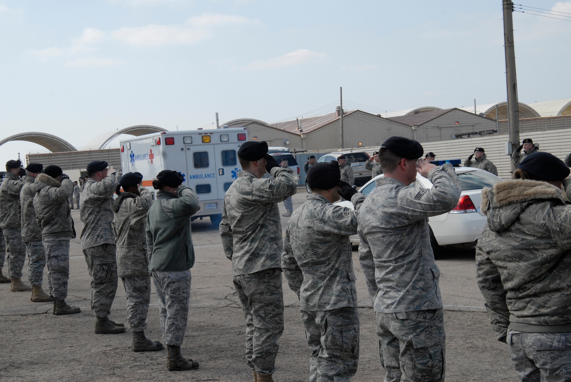 KUNSAN AIR BASE, Republic of Korea -- Members of the 8th Security Forces Squadron and Wolf Pack members from throughout the base salute the ambulance carrying the remains of Airman 1st Class Jarred J.Crowley during an Honor Call here March 18. A Memorial Service was also held, later that day, where Airman Crowley's friends, family and fellow Wolf Pack members paid their respects. (US. photo/Staff Sgt. Darnell T. Cannady)