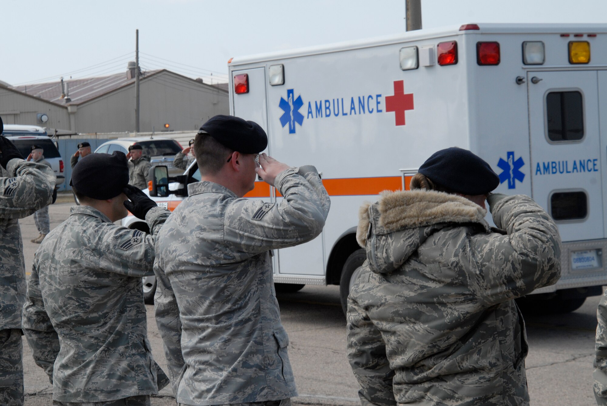 KUNSAN AIR BASE, Republic of Korea -- Members of the 8th Security Forces Squadron and Wolf Pack members from throughout the base salute the ambulance carrying the remains of Airman 1st Class Jarred J.Crowley during an Honor Call here March 18. A Memorial Service was also held, later that day, where Airman Crowley's friends, family and fellow Wolf Pack members paid their respects. (US. photo/Staff Sgt. Darnell T. Cannady)