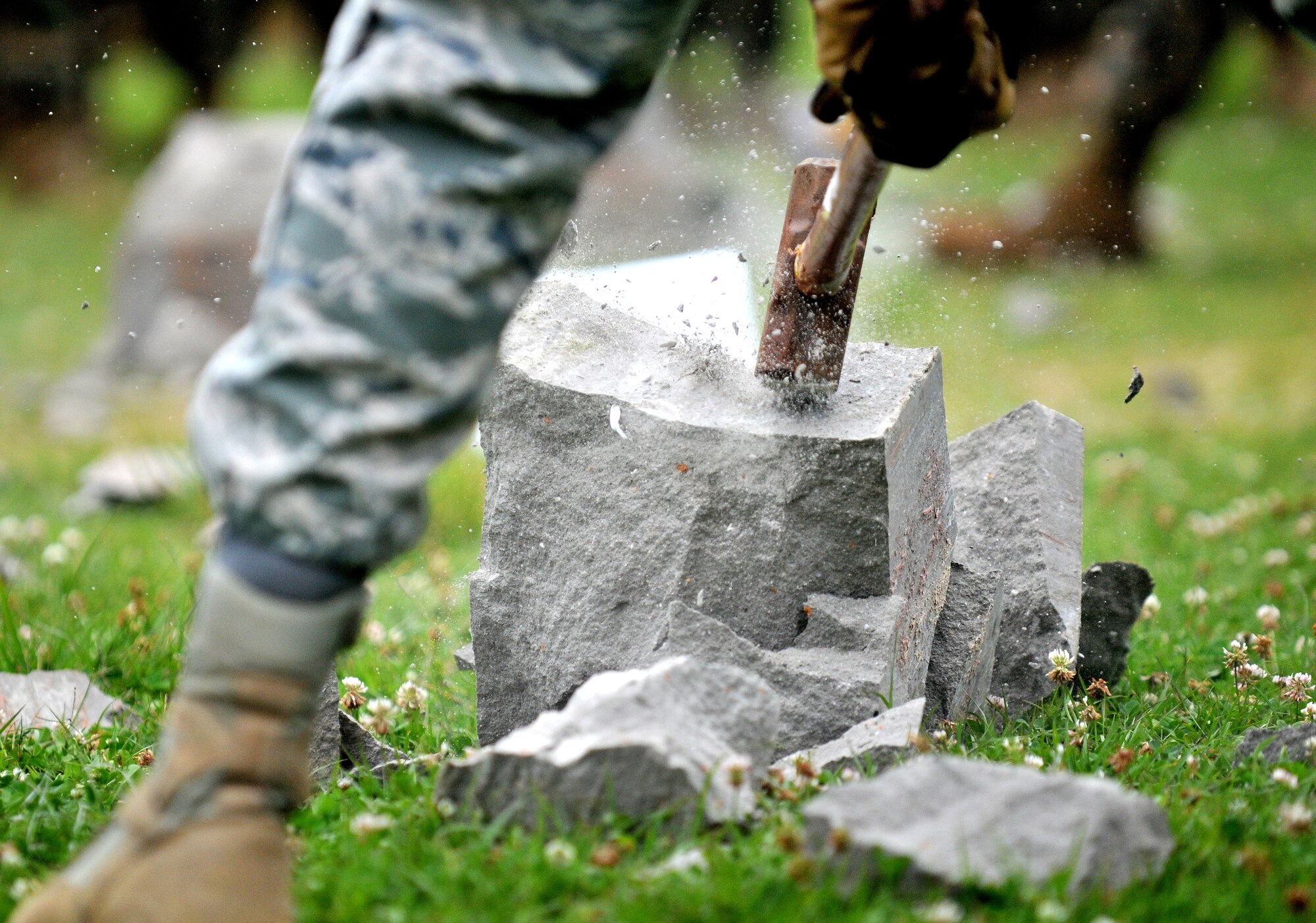An Airman from the 554th Red Horse Squadron Detachment 1 breaks a block on concrete in seach of a hidden piece of rebar. 
