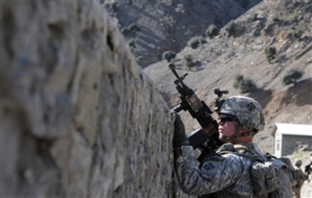 U.S. Army Spc. Roy R. Chamberlain, a gunner with 2nd Platoon, Bear Troop, 3rd Squadron, 61st Cavalry Regiment, Task Force Destroyer, peers over a canal wall during a patrol along the Kunar River in Kunar province, Afghanistan, on March 7, 2010.  The canal is part of a hydroelectric project designed to give power to residents in the Naray district.  International Security Assistance Forces are evaluating the progress made on the project.  