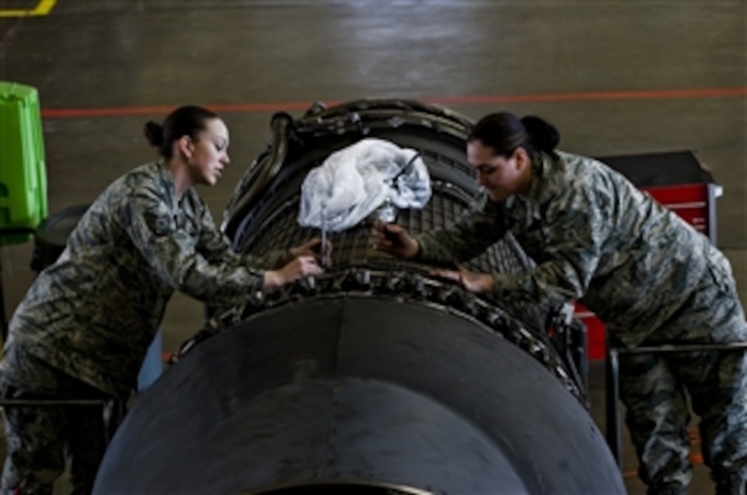 U.S. Air Force Senior Airmen Erica Plymale (left) and Angelique Hasz, 28th Maintenance Squadron aerospace propulsion journeymen, tighten bolts on a B-1B Lancer aircraft engine at Ellsworth Air Force Base, S.D., on March 11, 2010.  