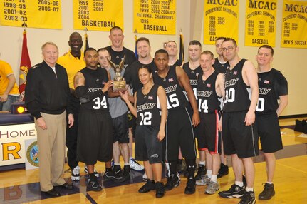 VADM Carl V. Mauney, deputy commander, U.S. Strategic Command, and Maj Gen Abraham J. Turner, chief of staff, U.S. Strategic Command pose with winners of the USSTRATCOM Army Navy basketball game held Mar 19 at Bellevue University's Gordon Lozier Athletic Center. Army beat Navy with a final score of 82 to 71.