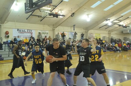 Charles Tillman of Team Army secures a rebound during the U.S. Strategic Command Army Navy basketball game held Mar 19 at Bellevue University&#039;s Gordon Lozier Athletic Center. Army beat Navy with a final score of 82 to 71.