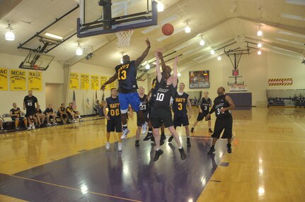 Members of Team Navy and Team Army battle for a rebound during the U.S. Strategic Command Army Navy basketball game held Mar 19 at Bellevue University&#039;s Gordon Lozier Athletic Center. Army beat Navy with a final score of 82 to 71.