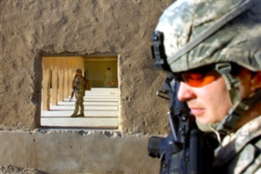 U.S. Army Staff Sgt. Gerald Frushon, right, and Pvt. Samuel Lima, provide security during a school assessment in Wesh, Afghanistan, March 16, 2010. Frushon and Lima are assigned to C Troop, 8th Squadron, 1st Cavalry Regiment.